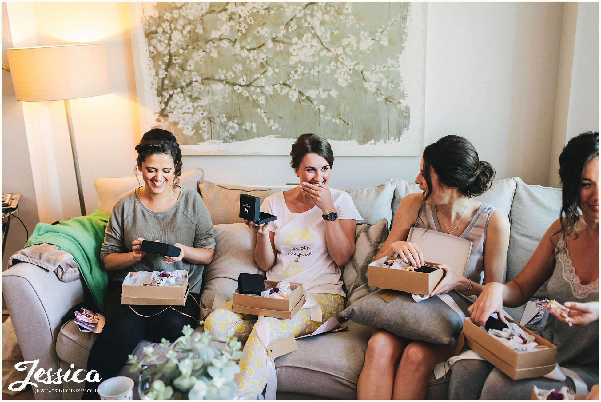 bridesmaid laugh whilst reading their thankyou cards