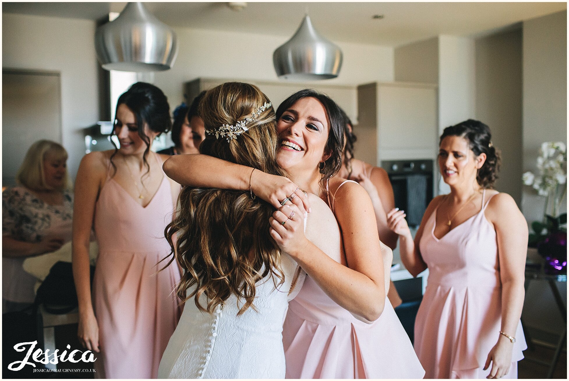 sister of the groom hugs her sister in law to be