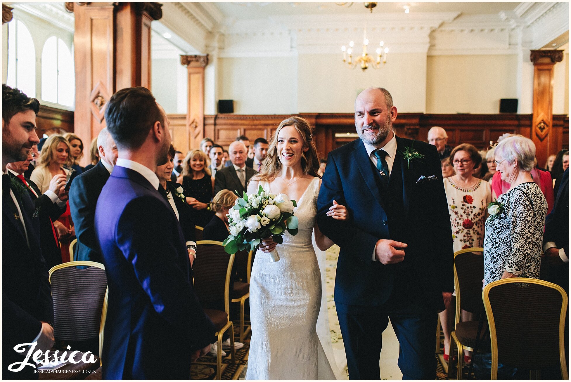 father of the bride walks his daughter down the aisle