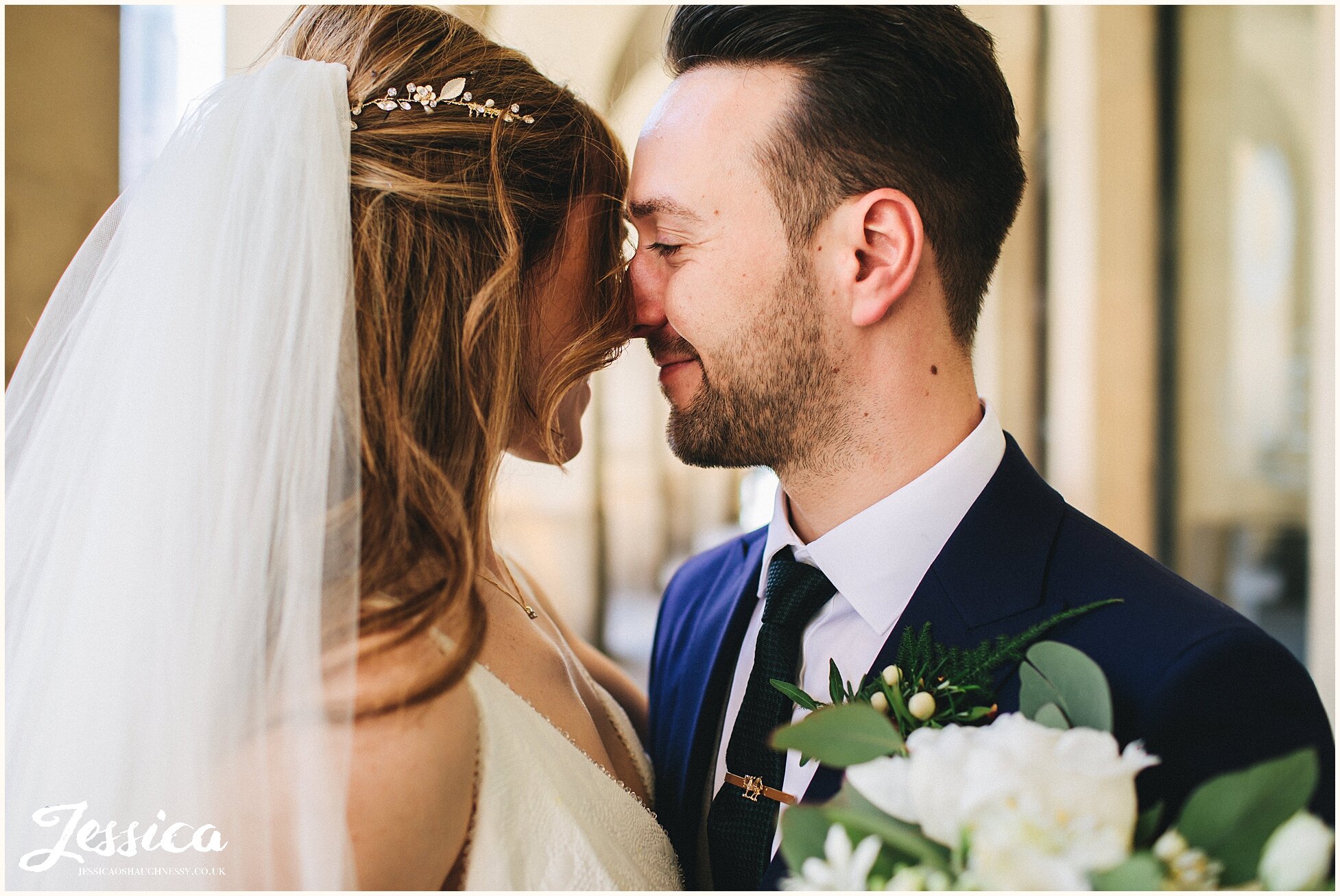 groom kisses the bride after their wedding ceremony at the midland hotel