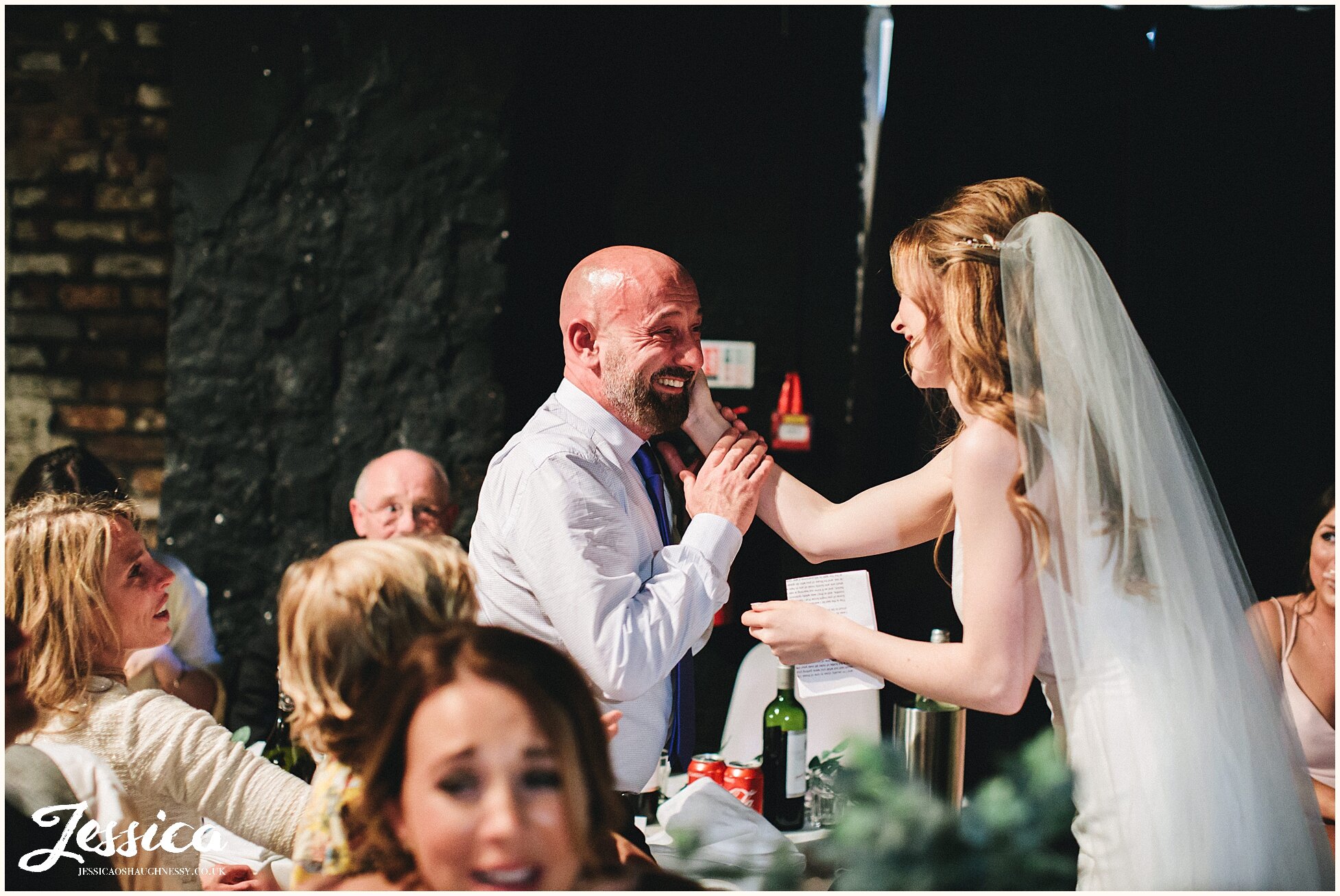 bride embraces wedding guest after she finishes her emotional speech