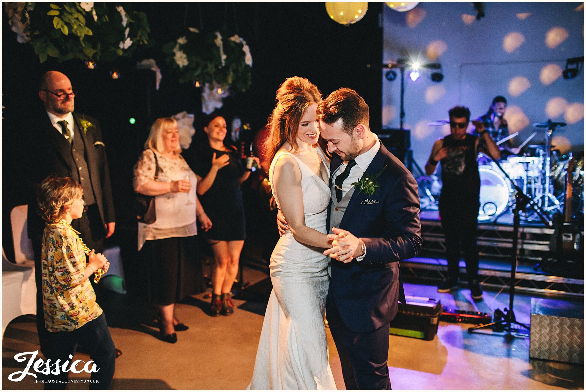 bride &amp; groom share their first dance in alternative wedding venue, hope mill theatre