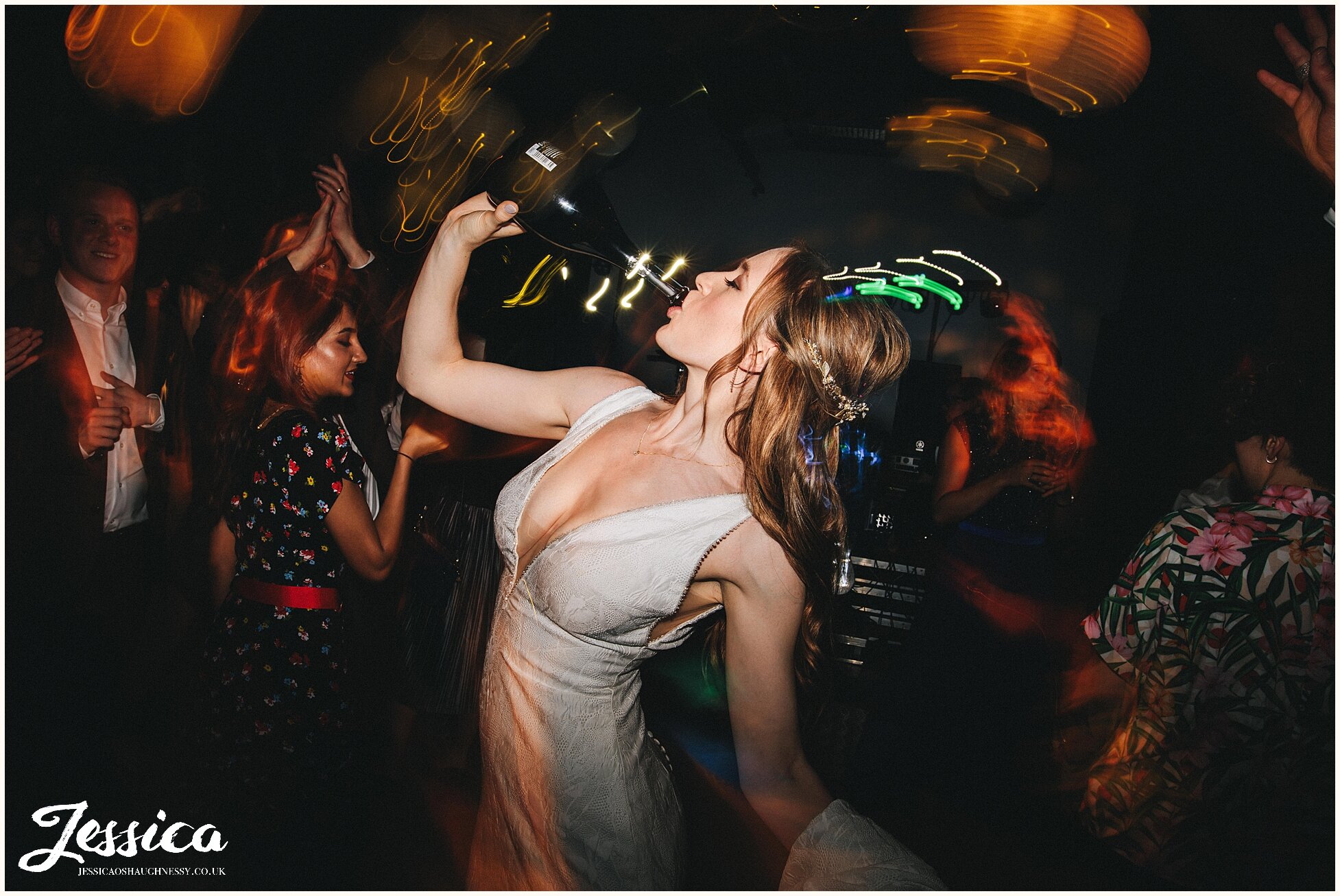 bride drinks champagne from the bottle