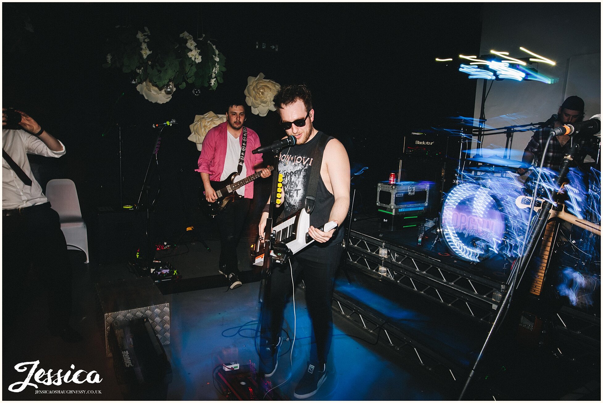 Band member plays guitar amongst guests on the dancefloor