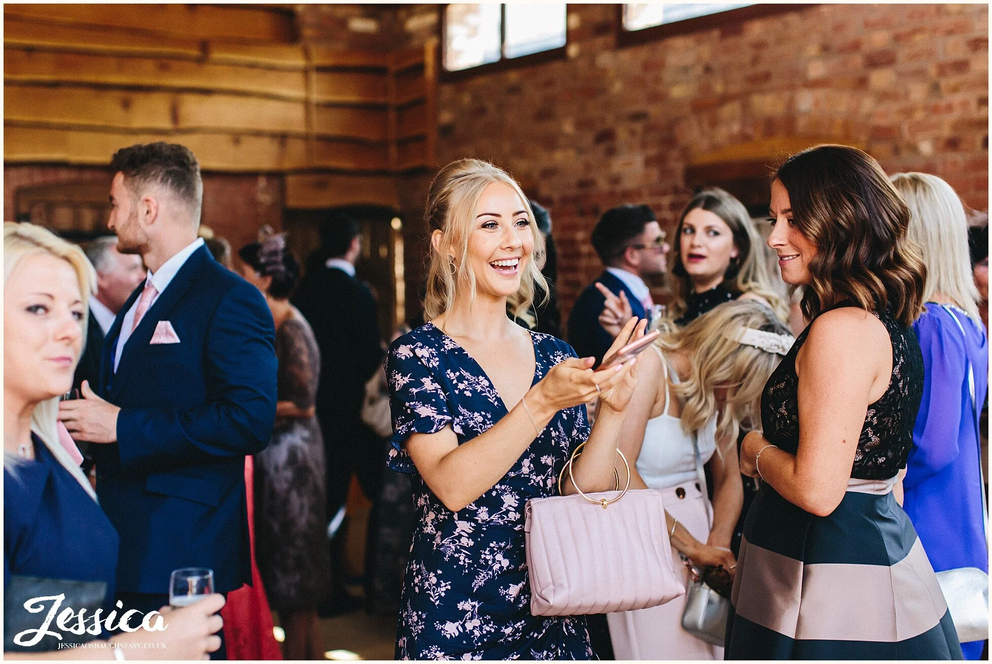 guests enjoy champagne in the oak barn