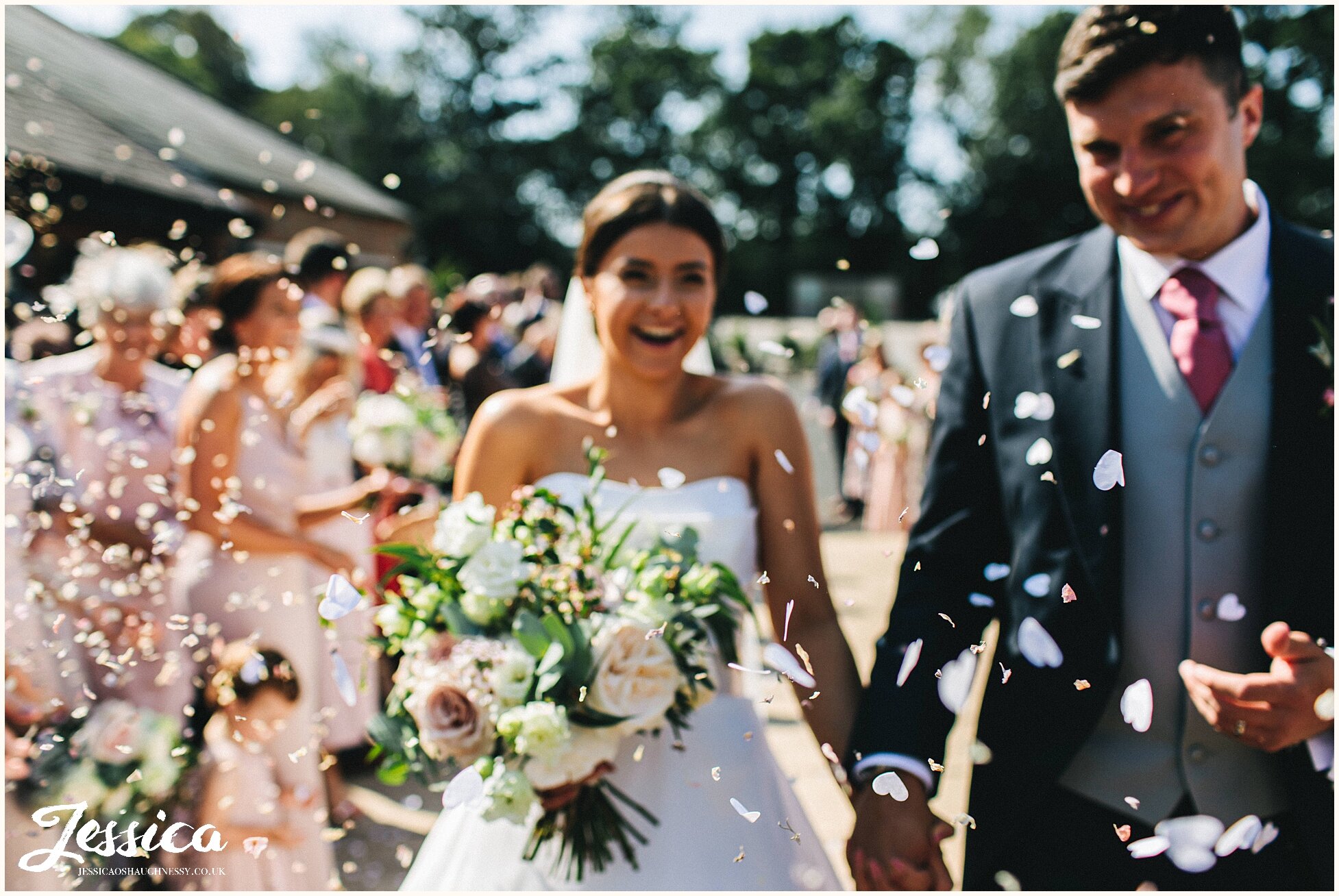 couple are showered in confetti at the leicestershire wedding