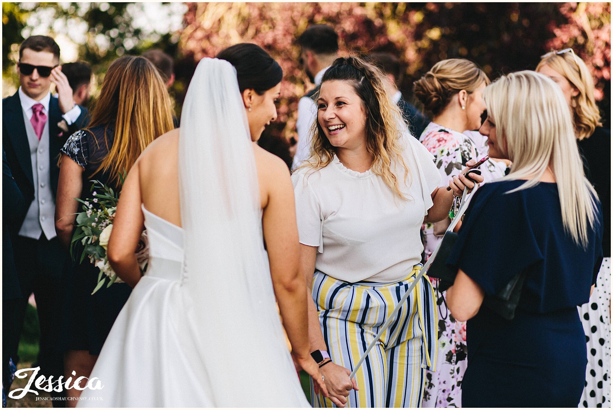 bride chats with friends during reception