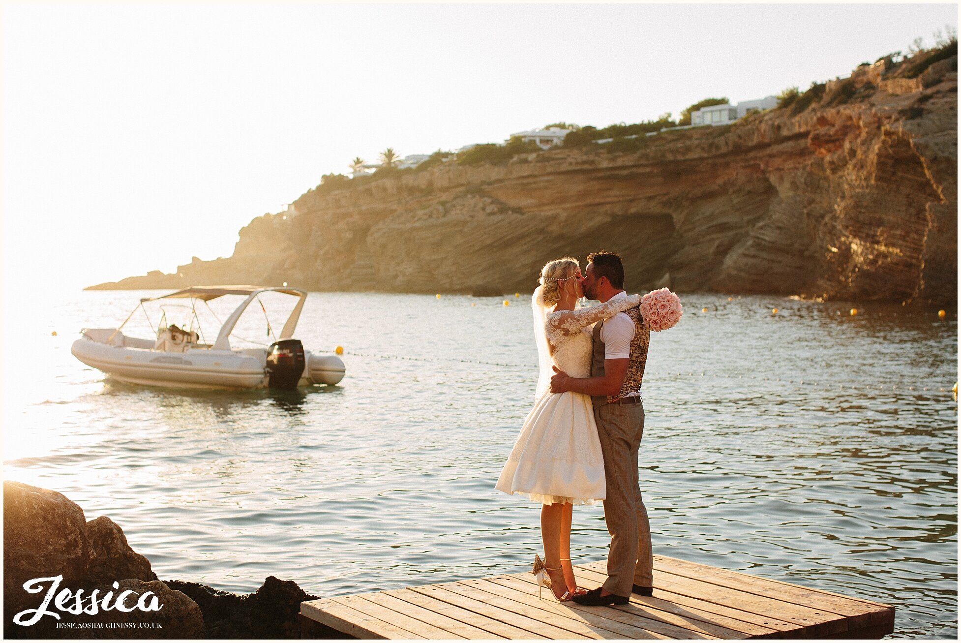 bride &amp; groom on the jetty on the beach, in the sunset - ibiza wedding photographer