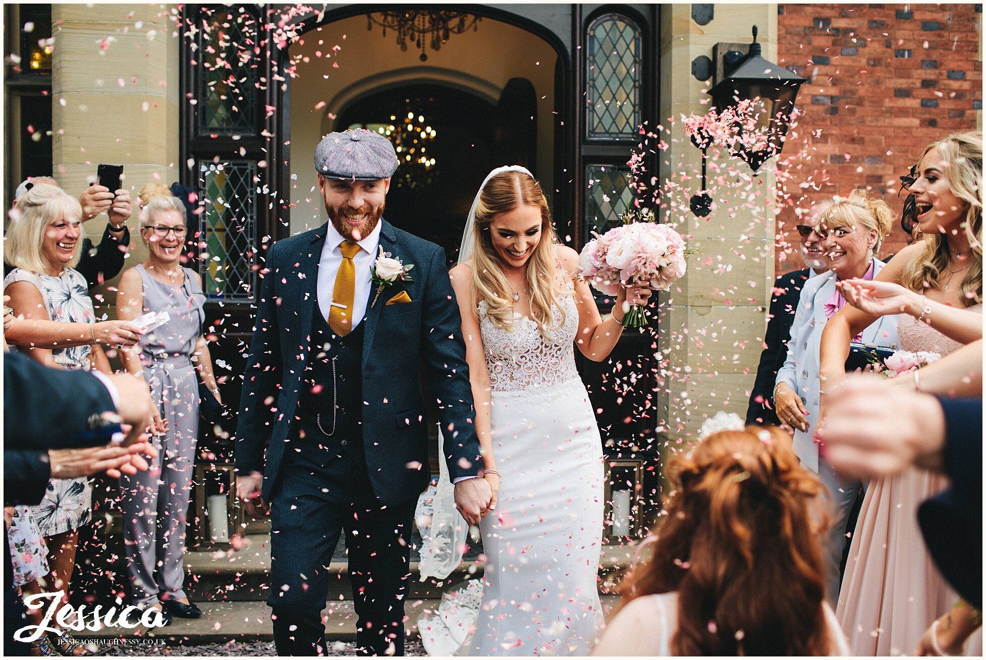 guests shower confetti over the newlywed's