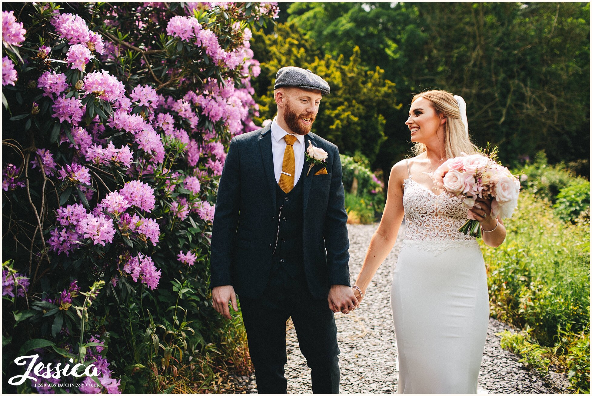 couple hold hands on their wedding day at tyn dwr hall