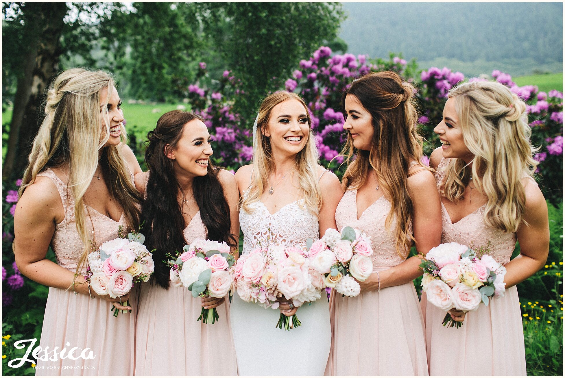 bridesmaids laughing with the bride at her north wales wedding