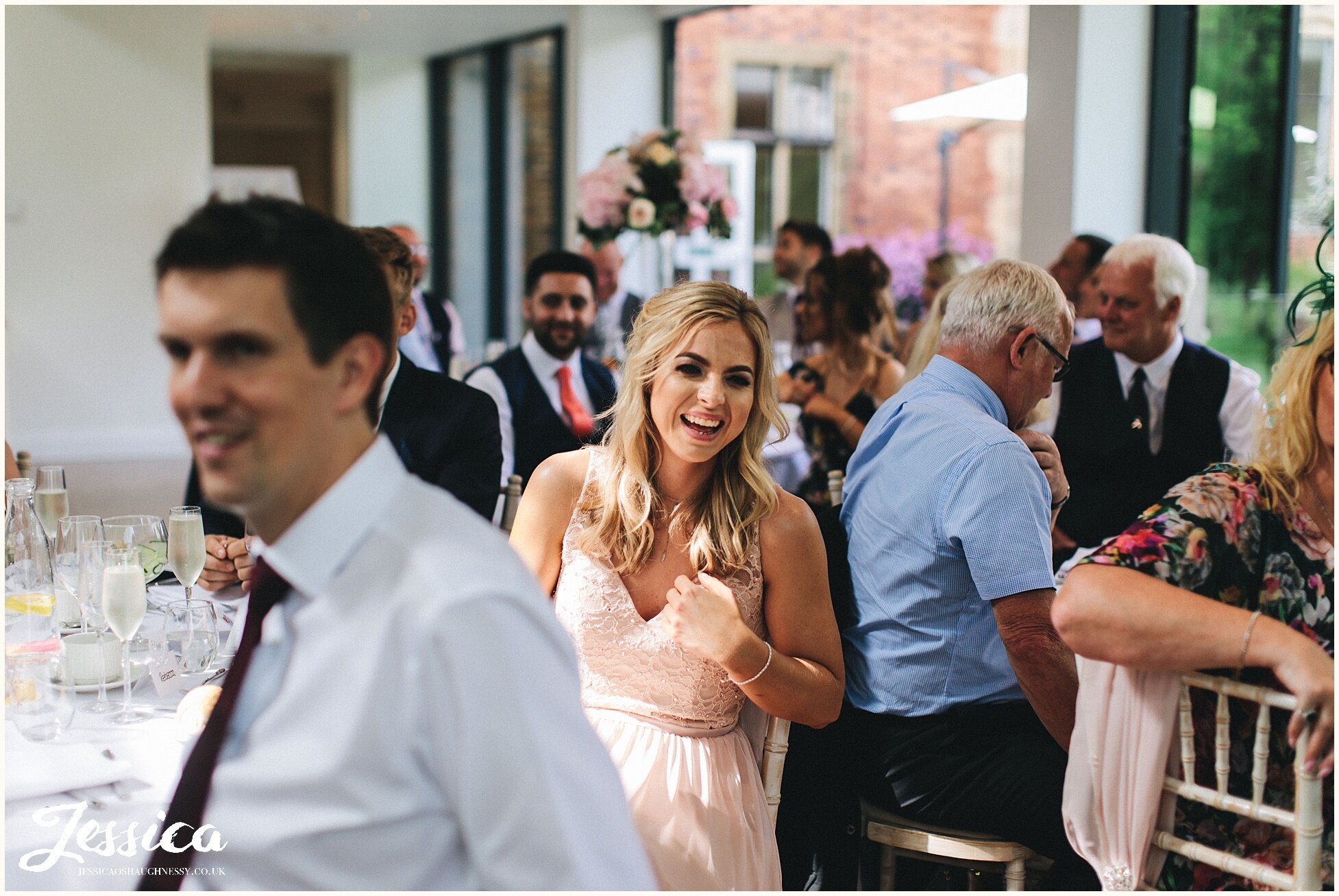 wedding guests smiling during the mother of the brides speech