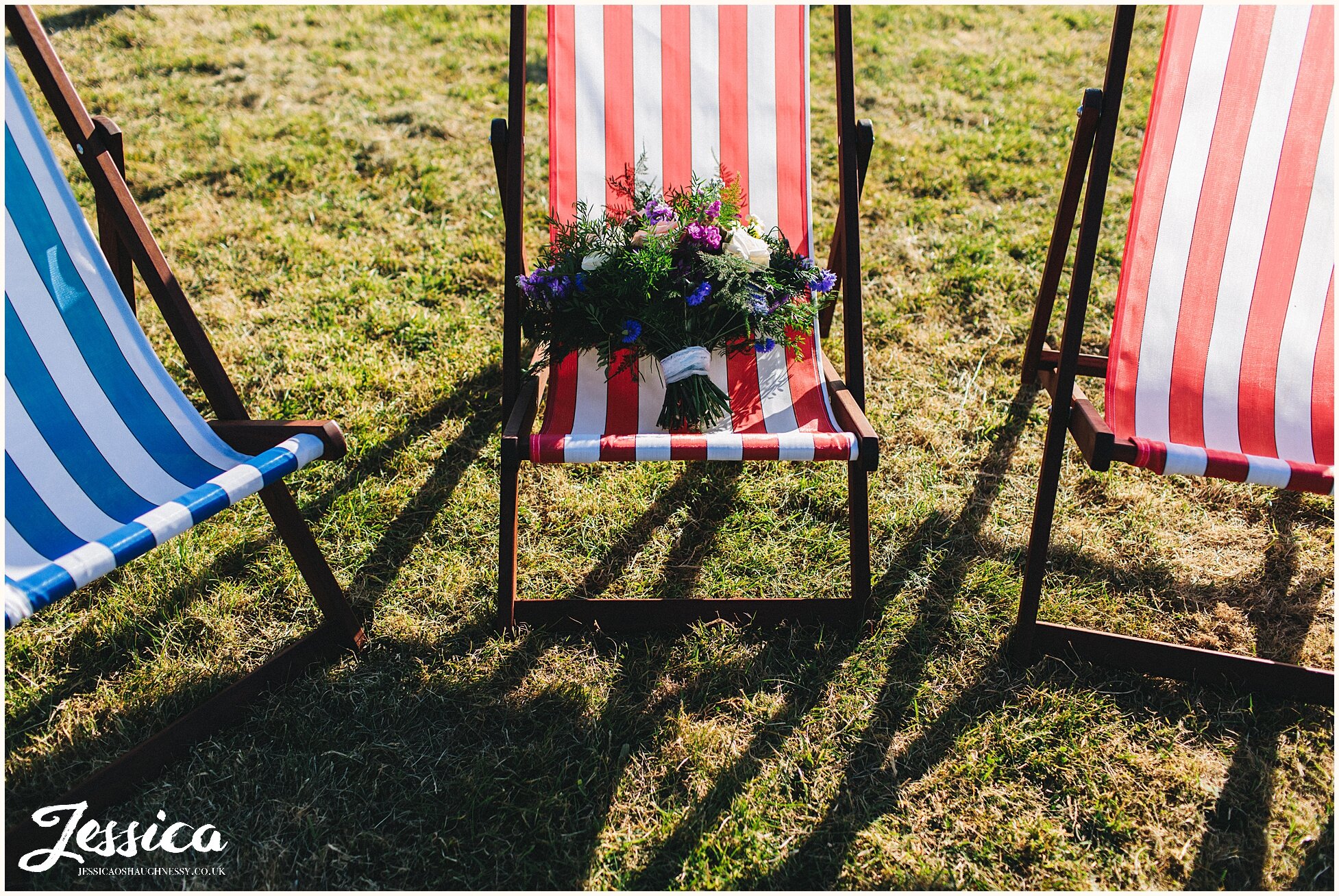 brides bouquet on stripy deck chairs