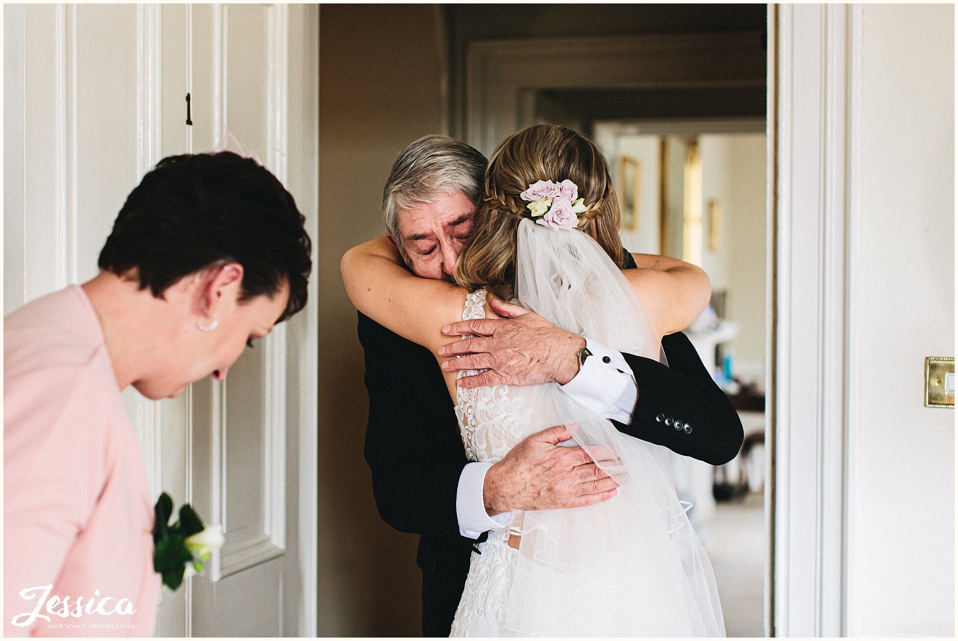 the bride hugs an emotional grandad