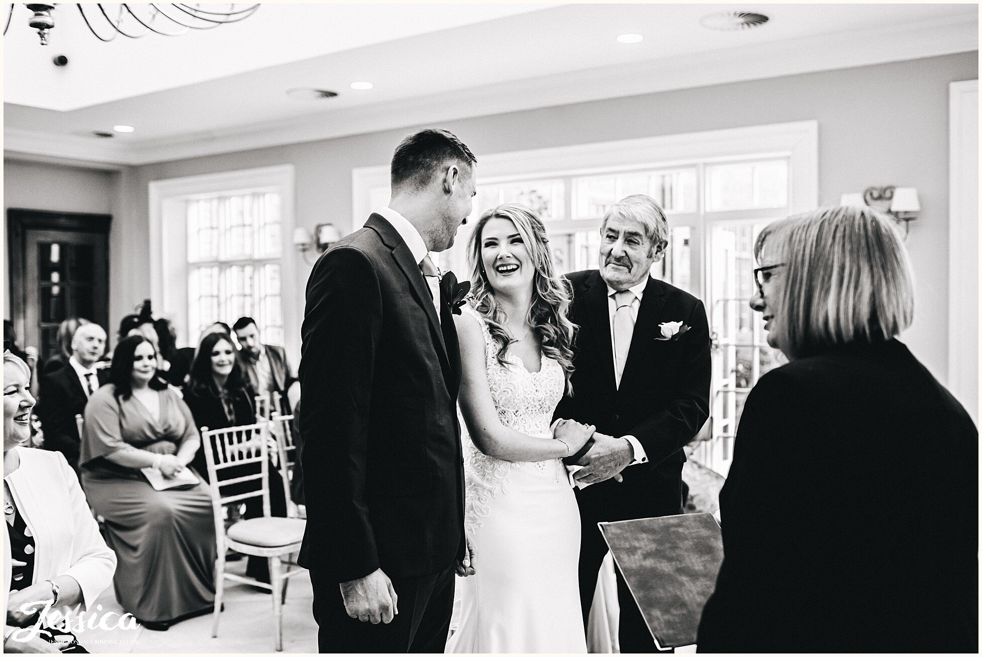 the bride laughs with her groom as they meet at the aisle