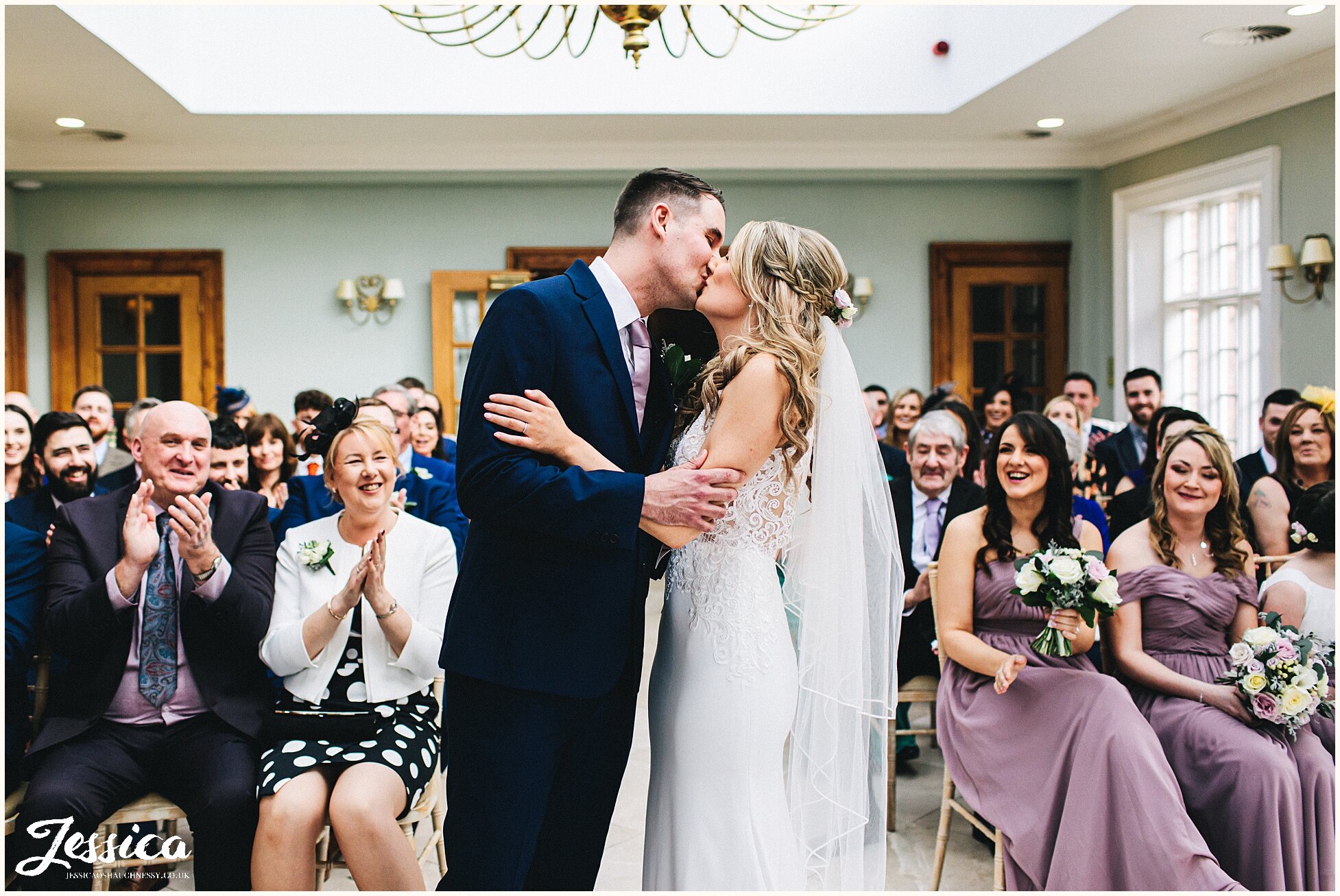 bride &amp; groom share their first kiss at Willington Hall in cheshire