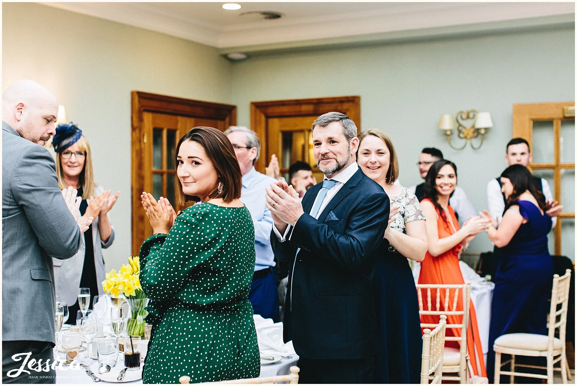 guests cheer as the couple enter