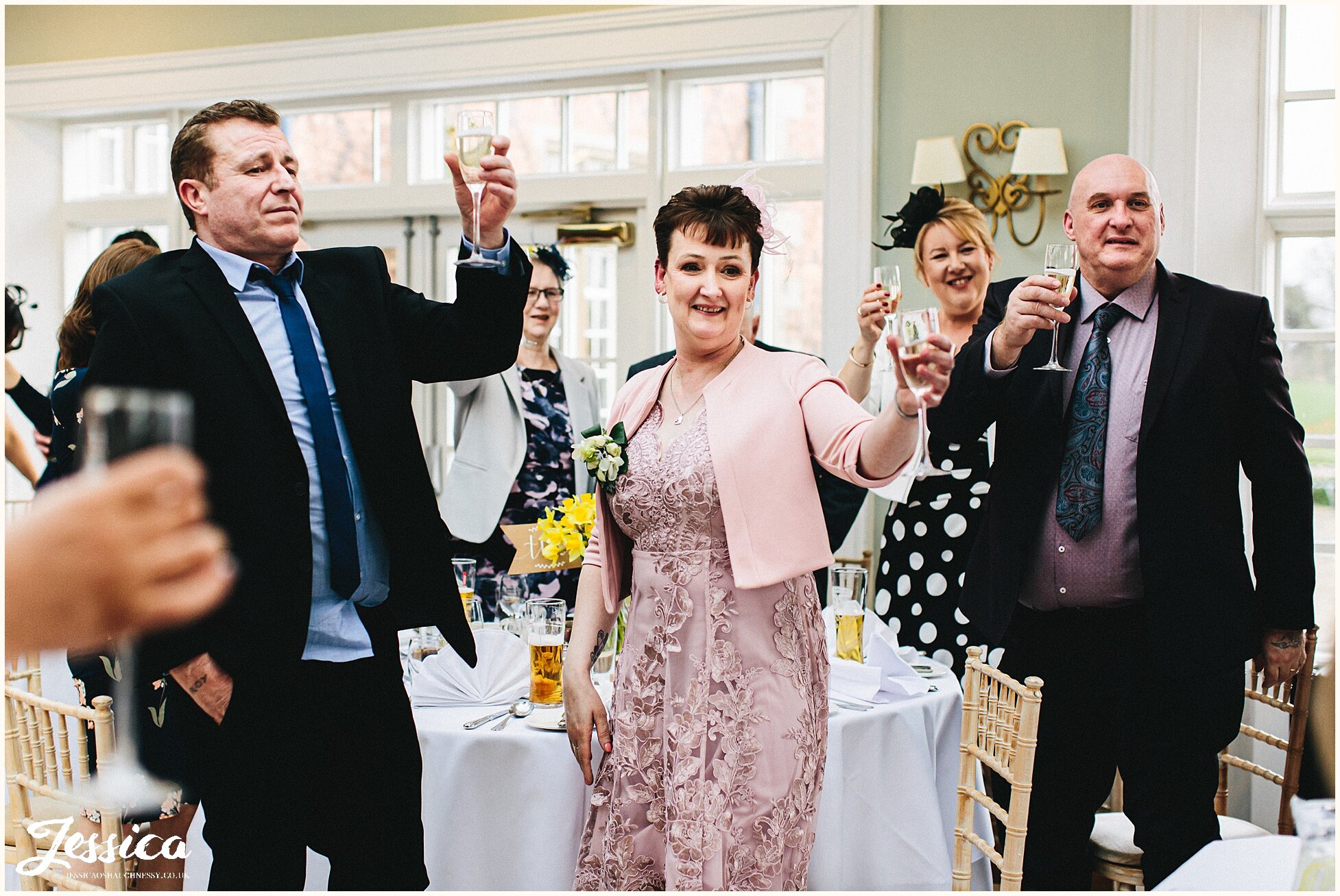 guests stand to give toast to the newly wed's