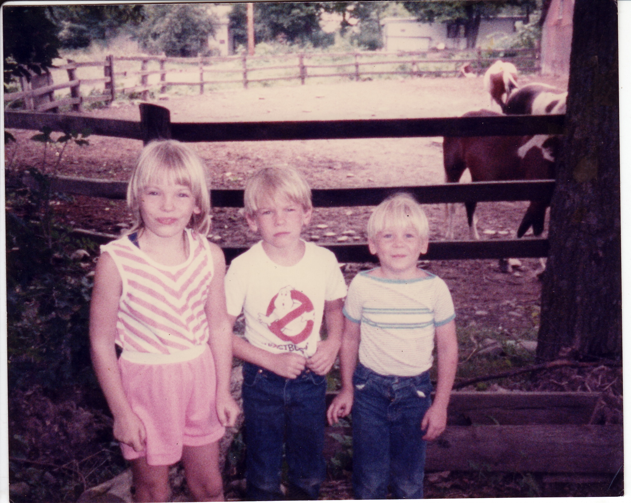 Kim with her brothers and some horses.
