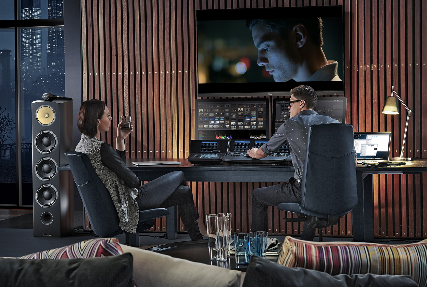 You know this lady pretentiously holding the drink is definitely giving this guy some shit about the color grade. Who wears leather pants to a color grading session?