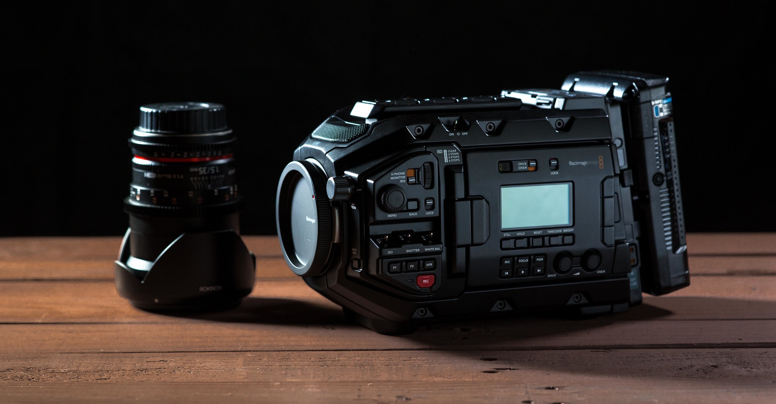 The Ursa Mini Pro with an IDX V-Mount battery next to a Rokinon 35mm