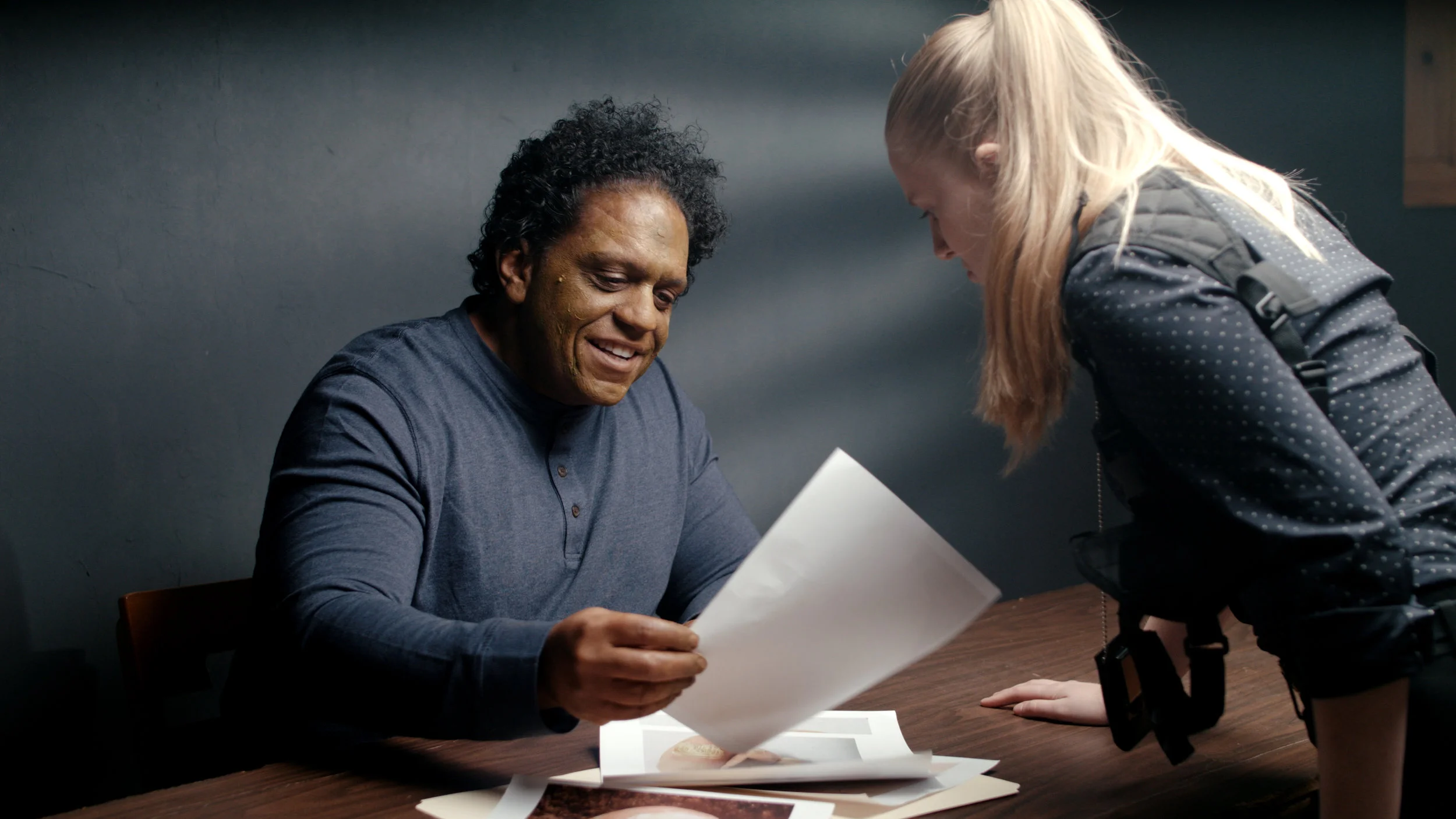 You can see here that the actress is leaning in under that top light. Pattern on the wall behind the criminal gives some visual interest and adds another layer of dimension to the scene.
