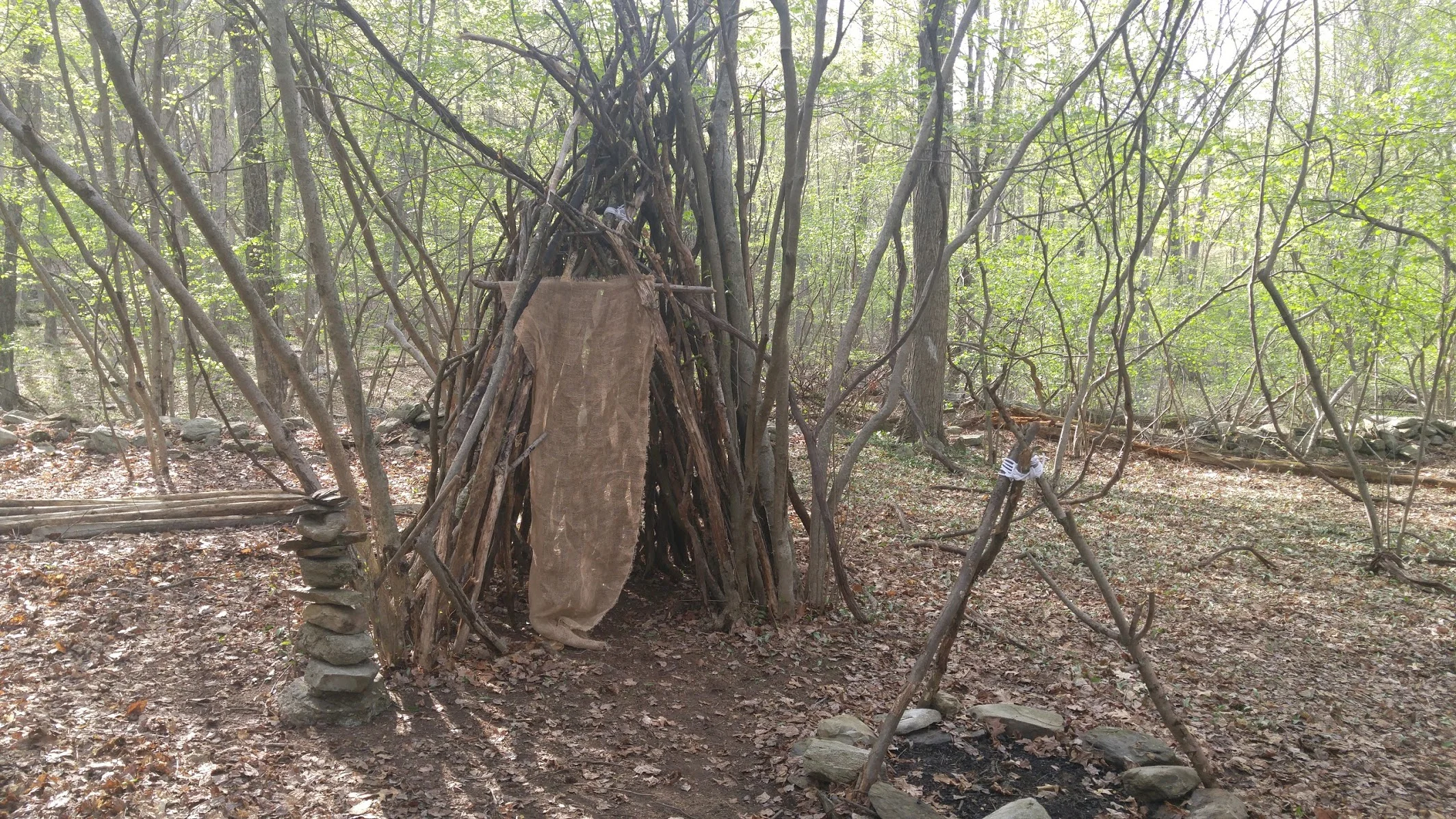 A pile of rocks and a piece of burlap across the door of the wikiup are the final steps.