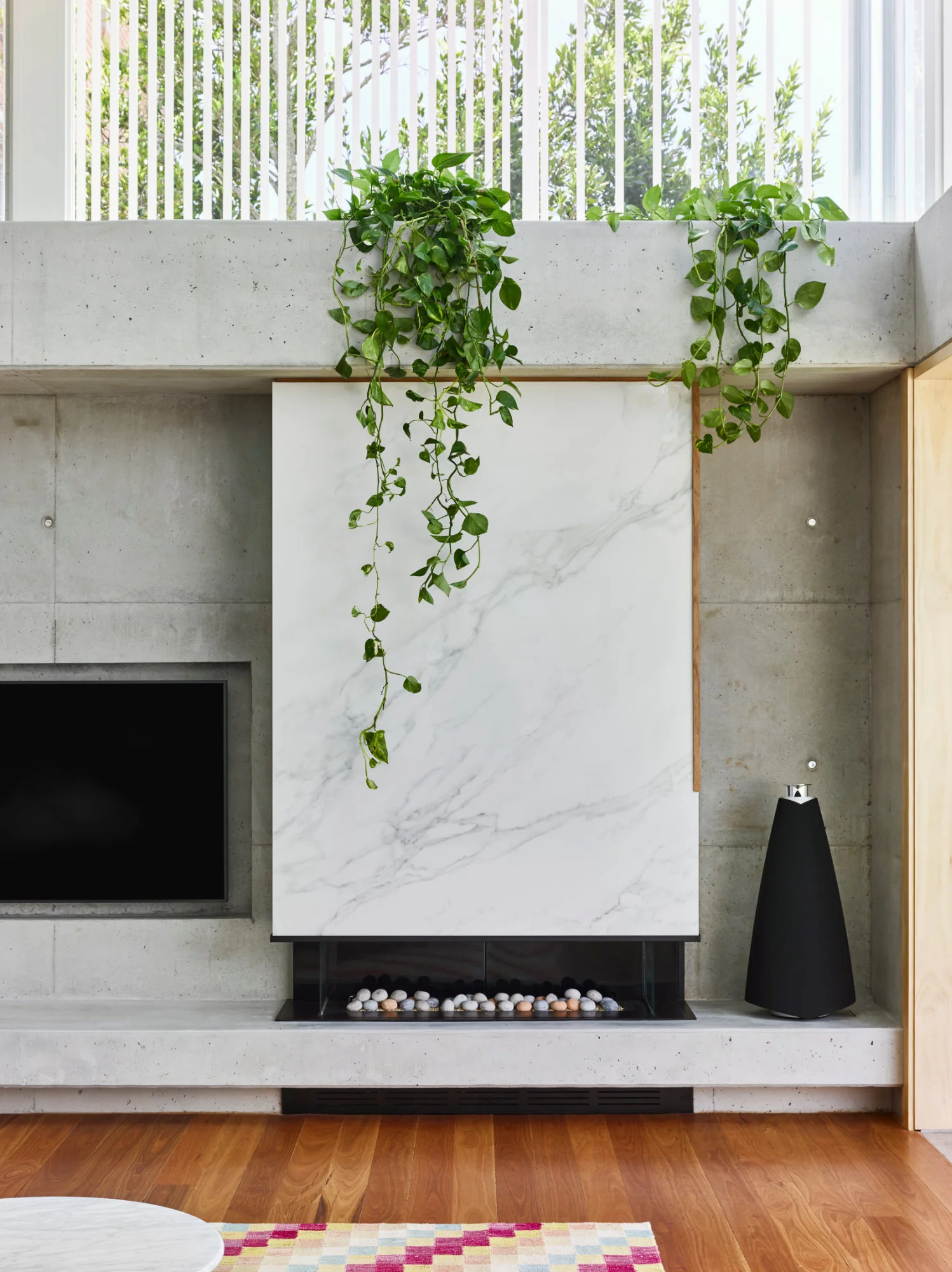  Marble features on a contemporary fireplace, interior architecture allowing light and air through the space in New Farm, Brisbane. 