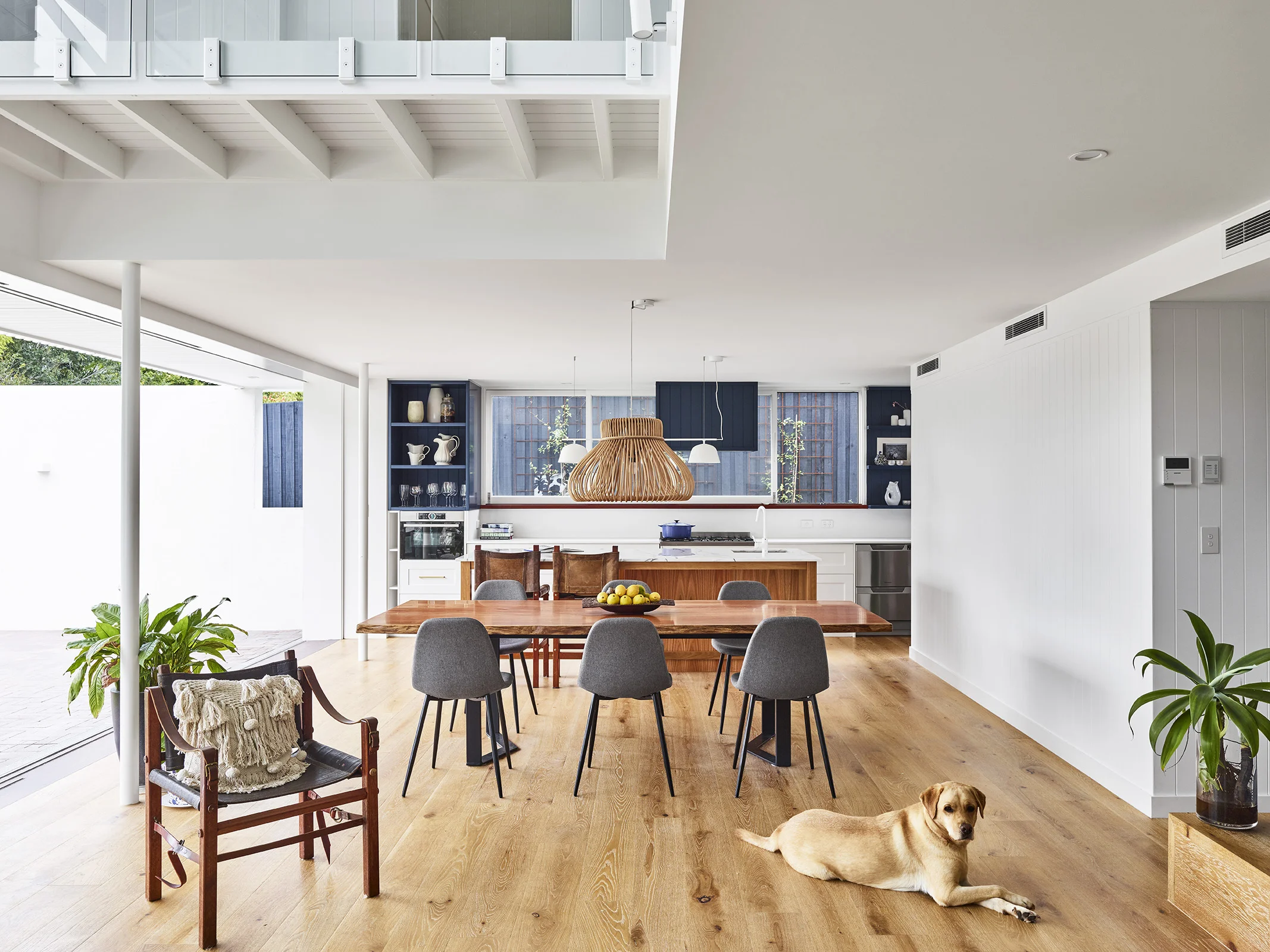   An architecturally designed modern open plan, white kitchen with pops of colour and timber accents for warmth in Gordon Park, Brisbane.   