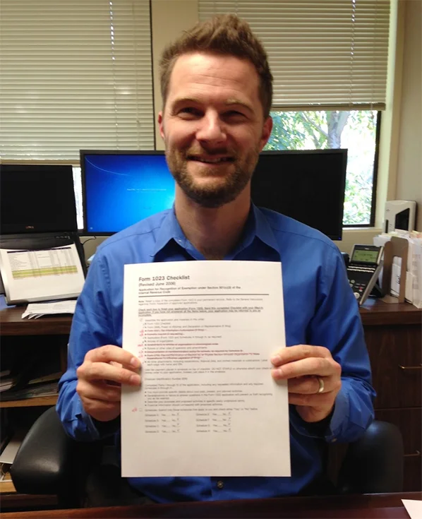 Dashiell Thompson with Eckhoff Accountancy holding our completed file, ready to be mailed!