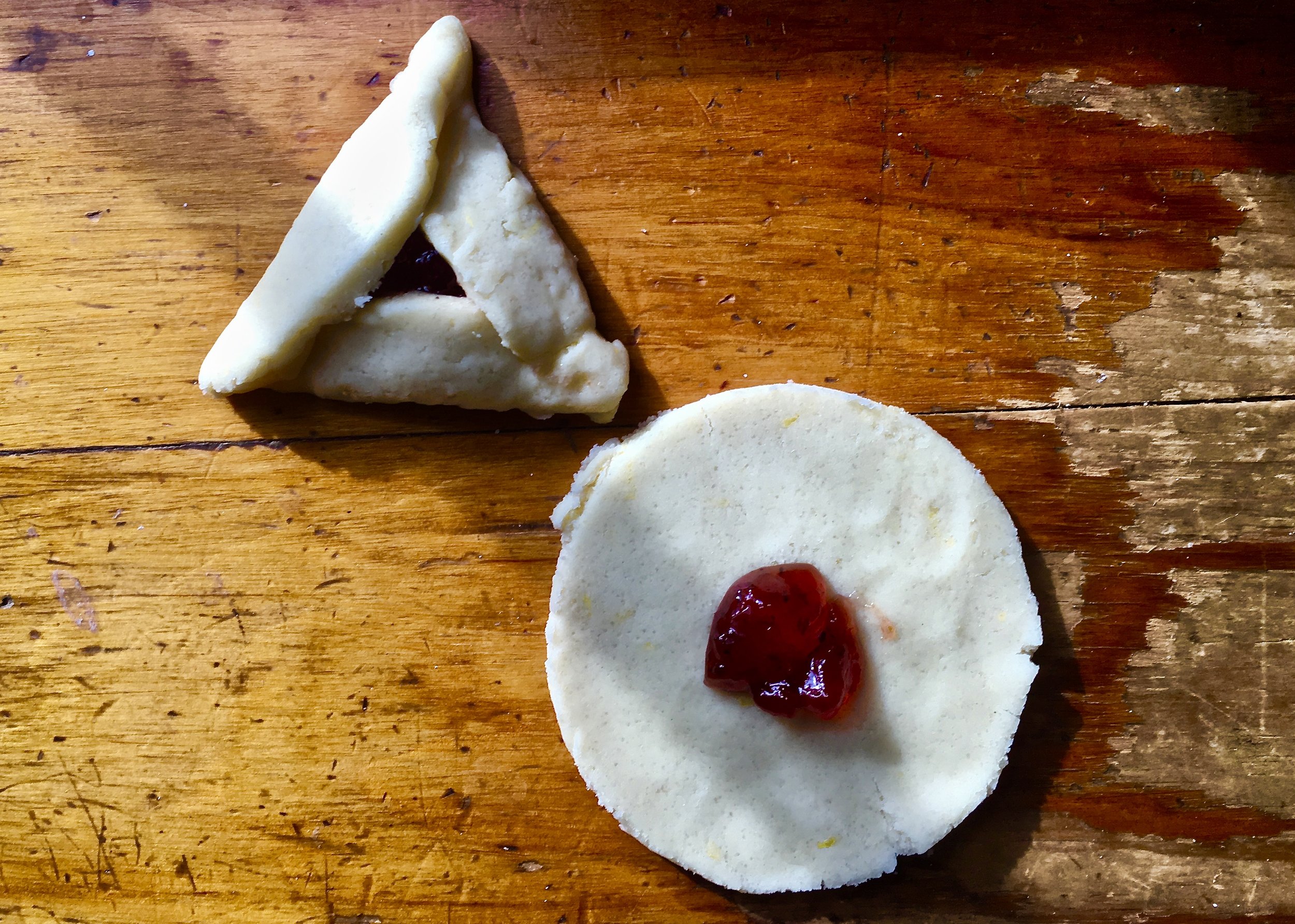 A teaspoon of filling is all that you need. Once filled, fold dough into a triangle.