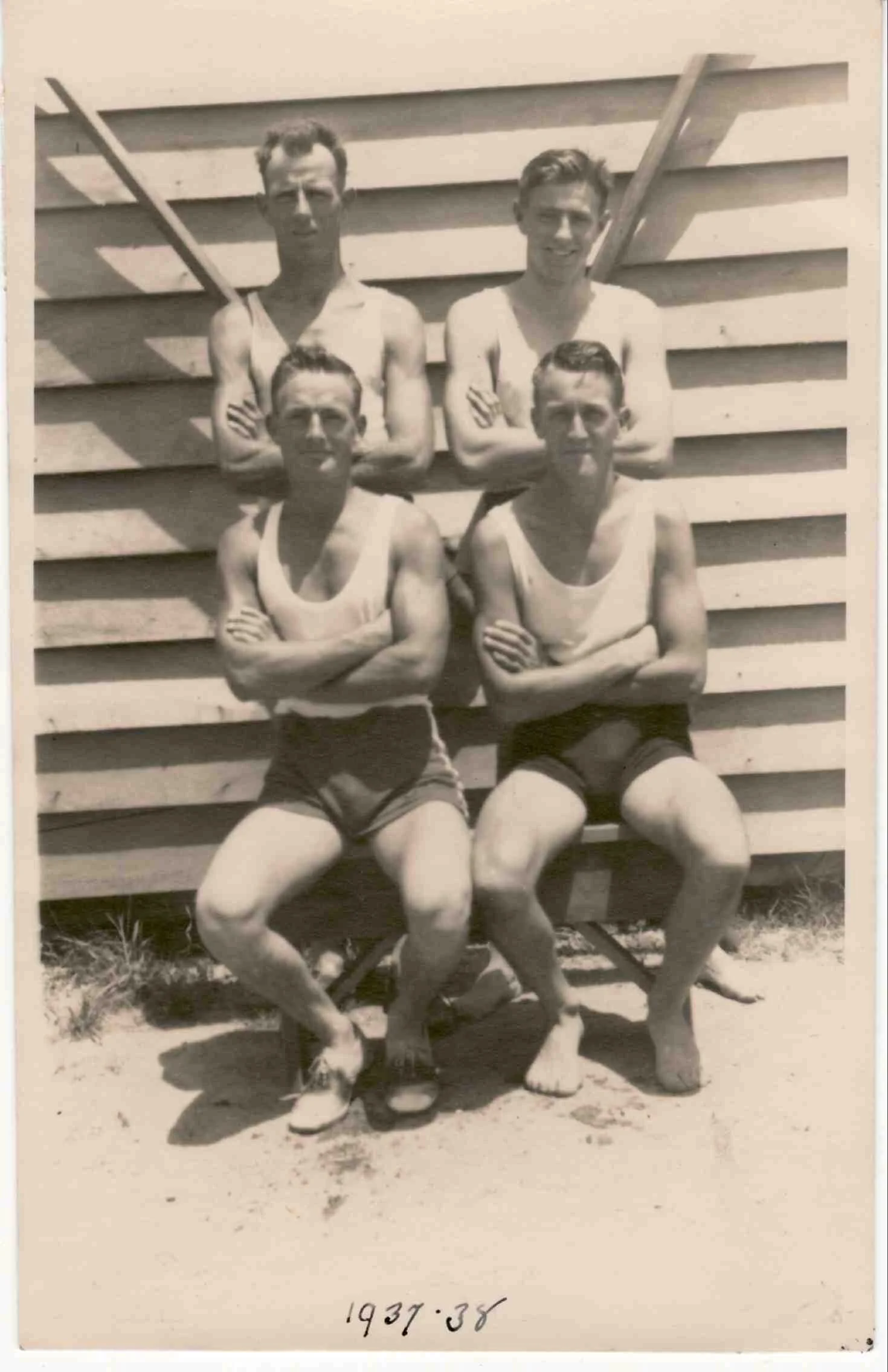 Can anyone help in identifying these dashing young men pictured outside the old rowing "shed" seated front right is one of the Dent brothers.