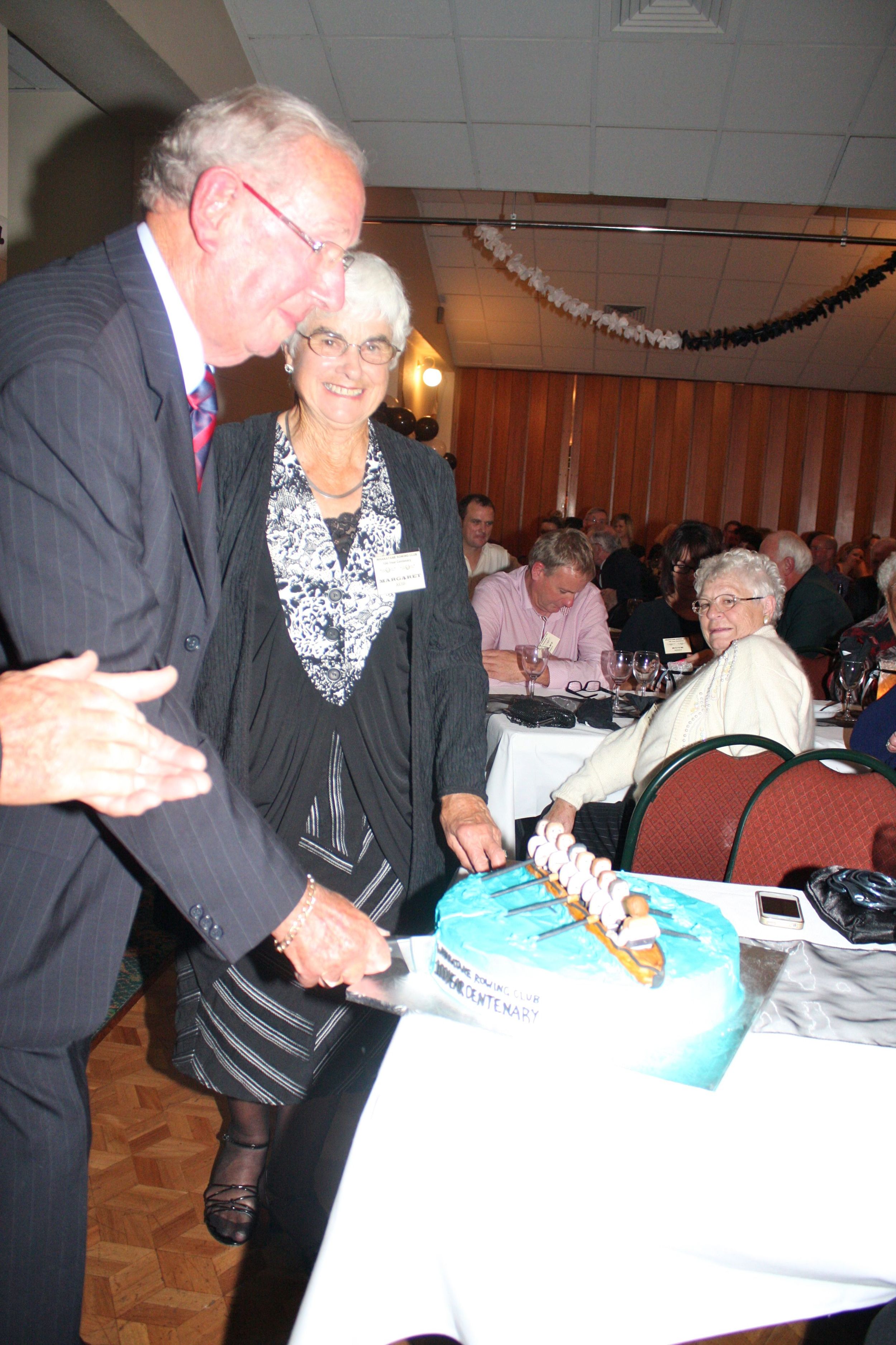 Cutting the Centenary Cake is Bob Byrne ably assisted by Margaret Reid.