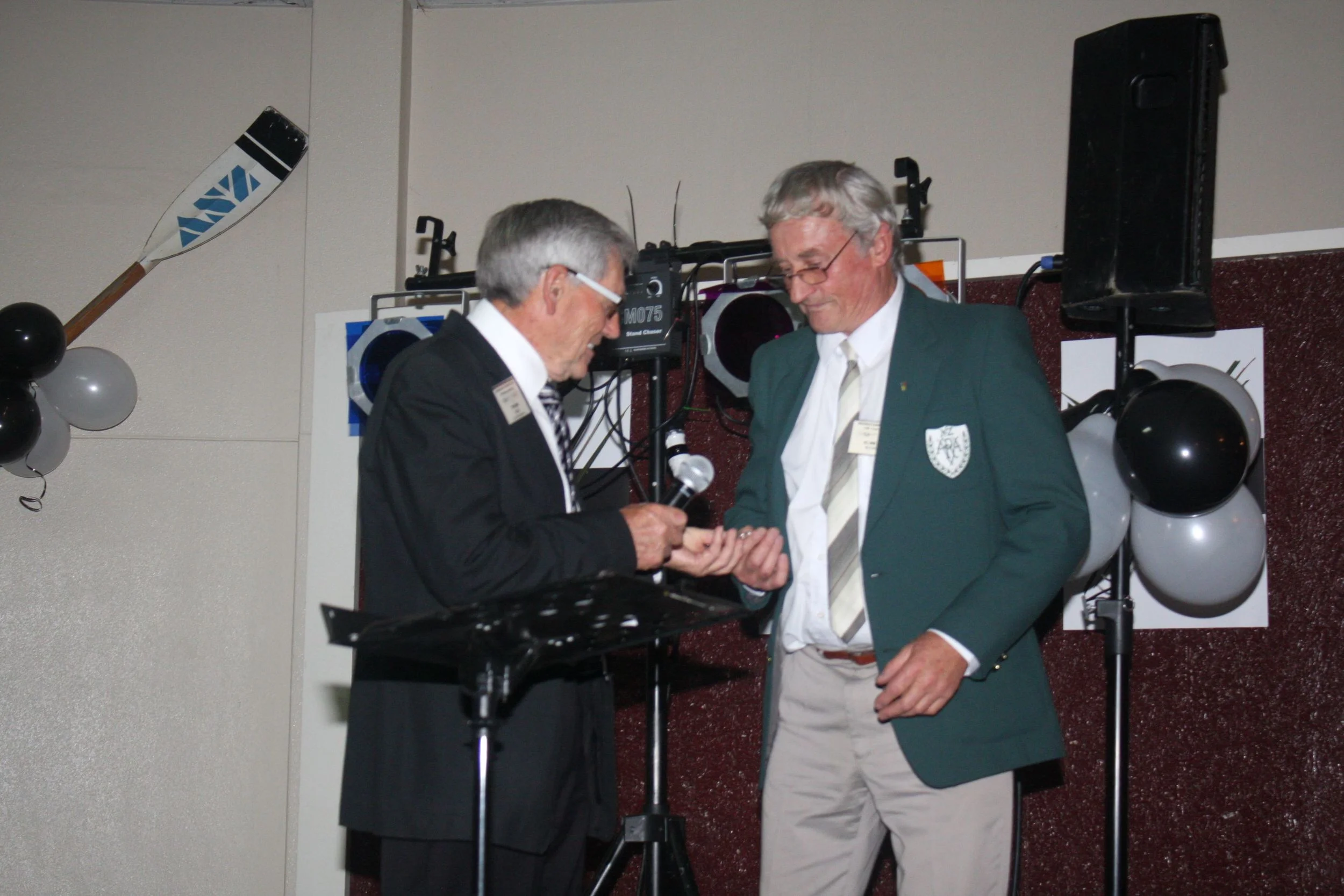 Club President Tom Reid presents Chick Hammond with his life membership badge.