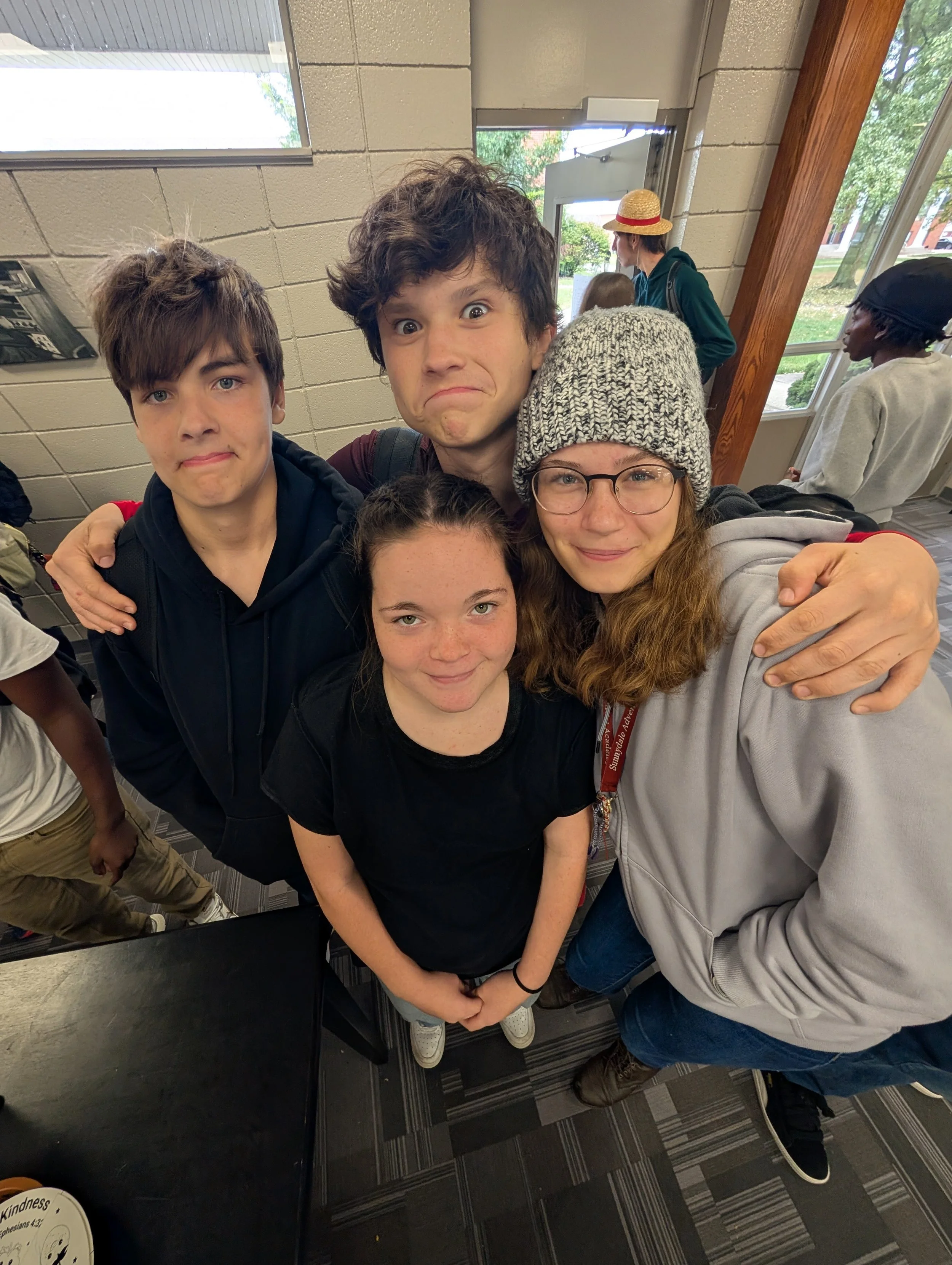 three students posing on in the cafe