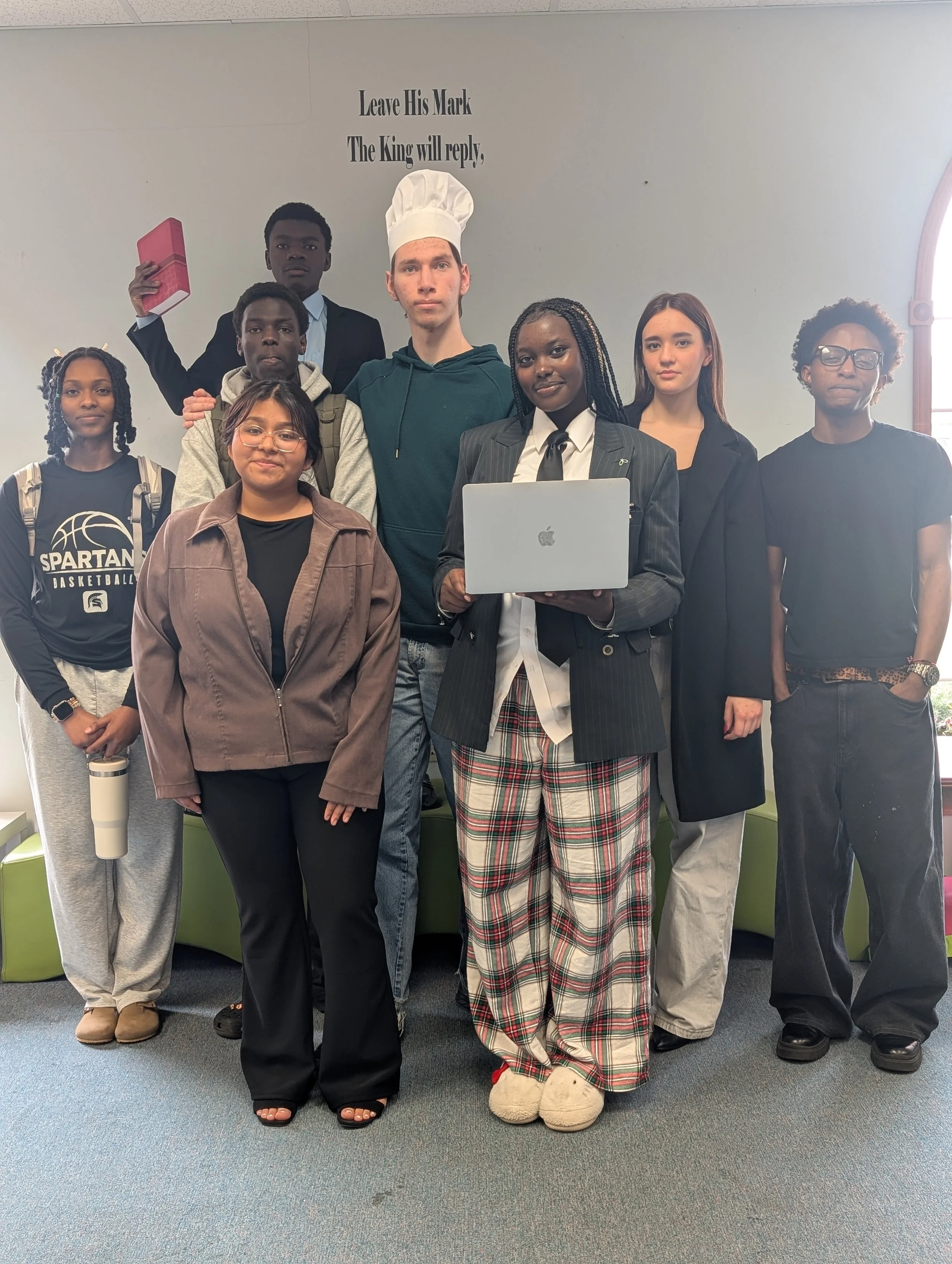 Group of students smiling for photos in funny outfits