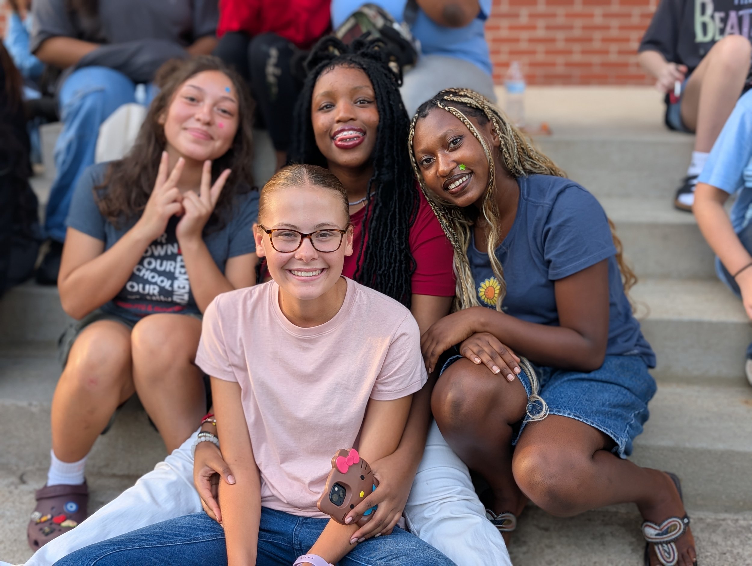Four girls smiling for the camera