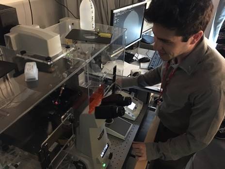 Antonis shows the magnetic tweezers to Year 10 students