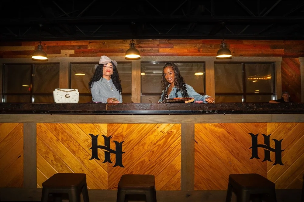 Guests behind the wooden High Horse railing in the elevated VIP area.