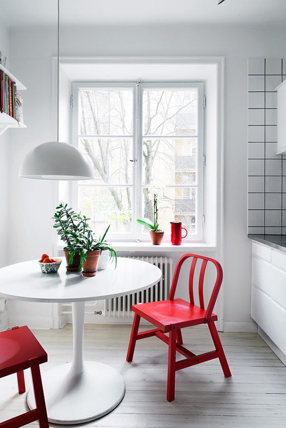 I love the pop of colour from these red chairs in a bright white space. See more here .