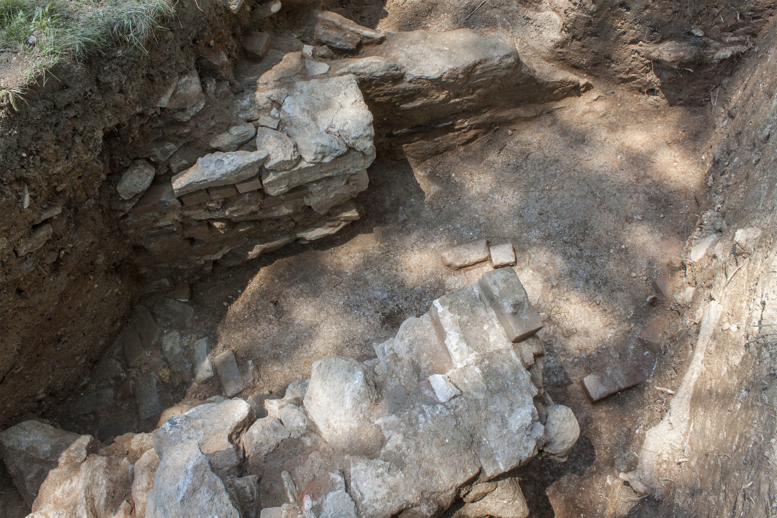 View of the walls and path from above the pit, facing west. 