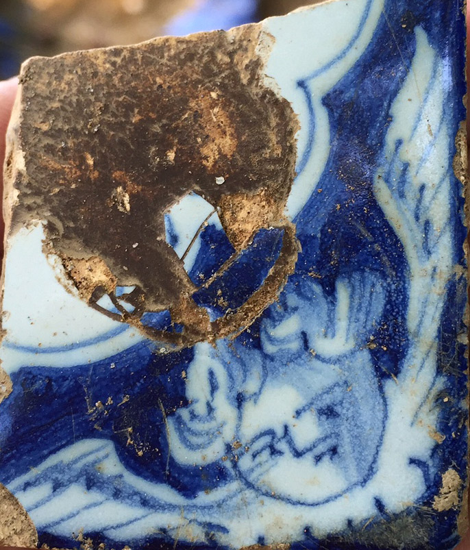 Piece of 18th century delft featuring a cherub's head, found during the excavation. 