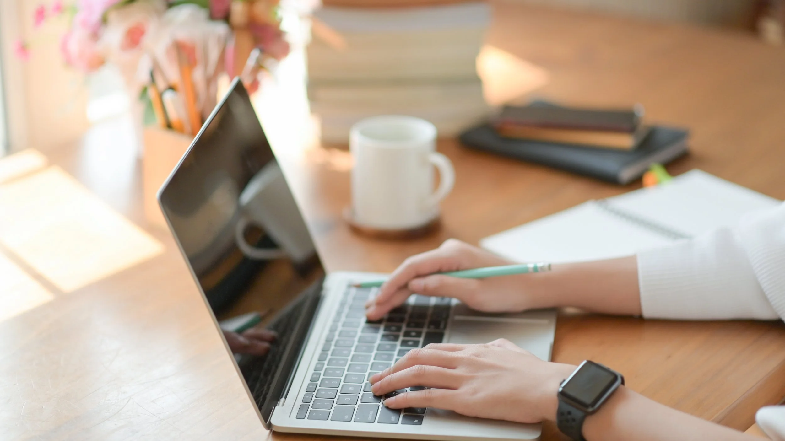 close-up-young-girl-hand-is-using-laptop-on-a-wood-2023-11-27-05-00-30-utc.jpg