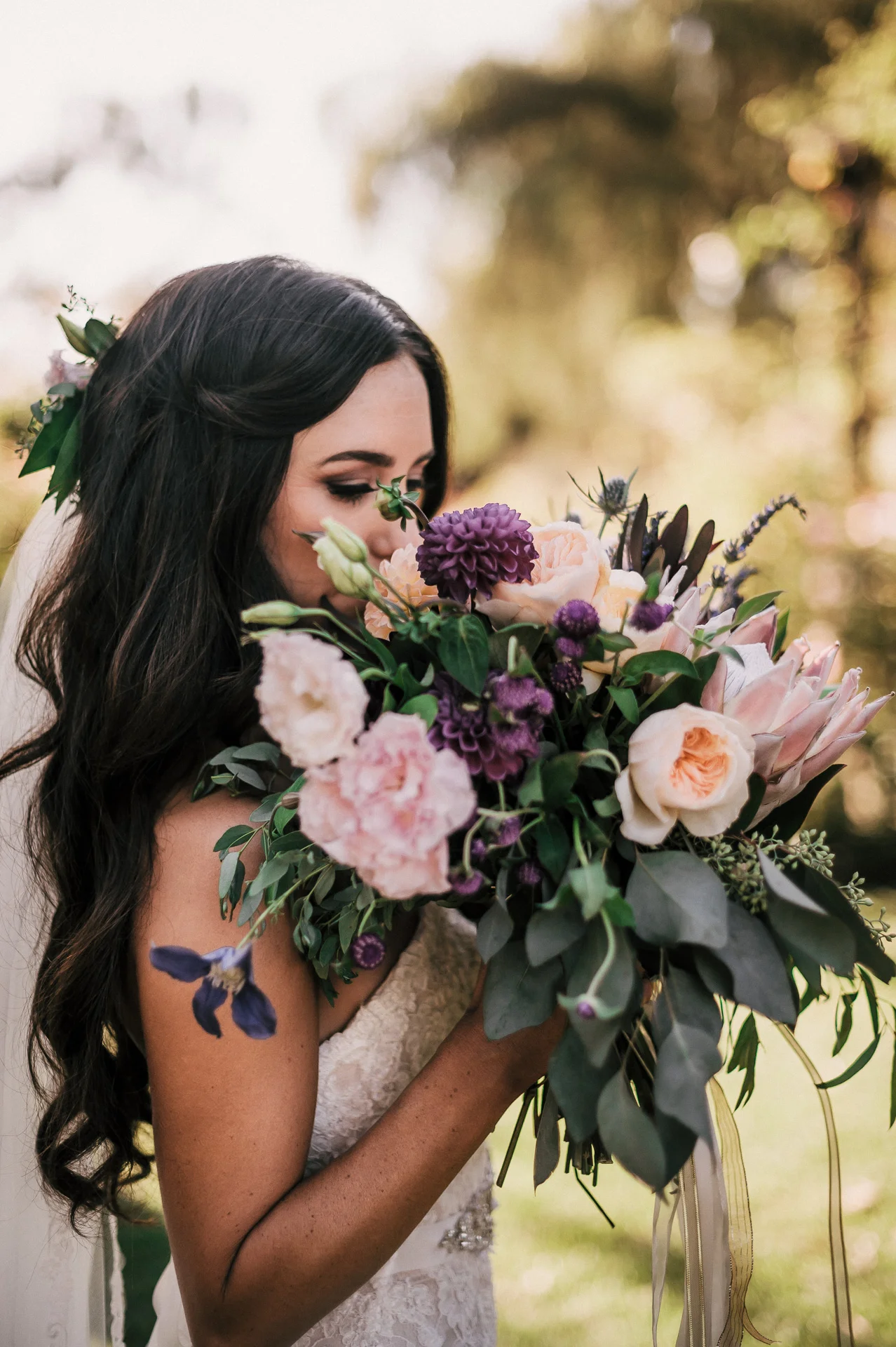 Bride poses with her vintage bouquet