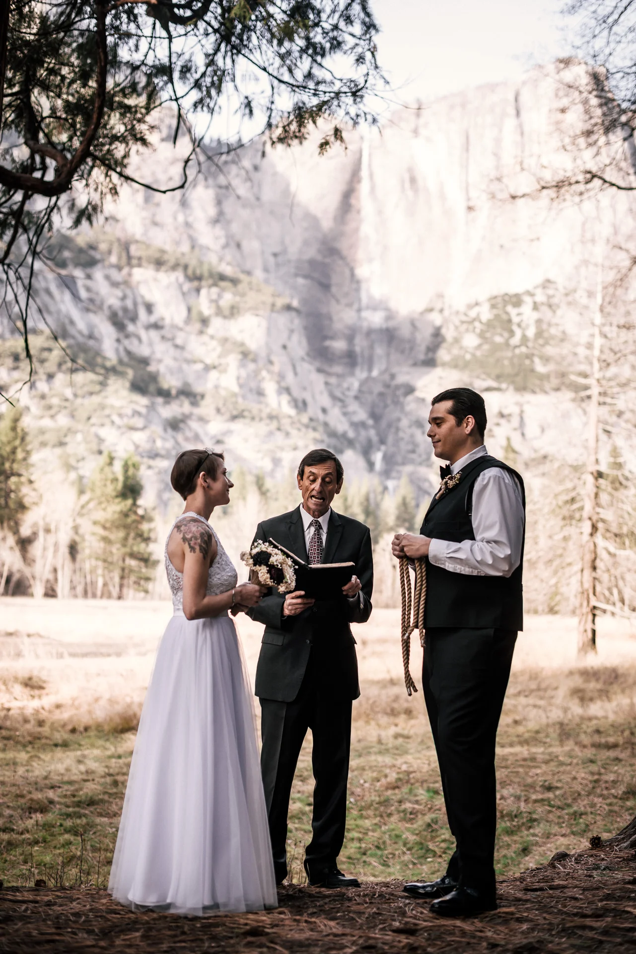 bride and groom prepare to tie the knot in yosemite national park