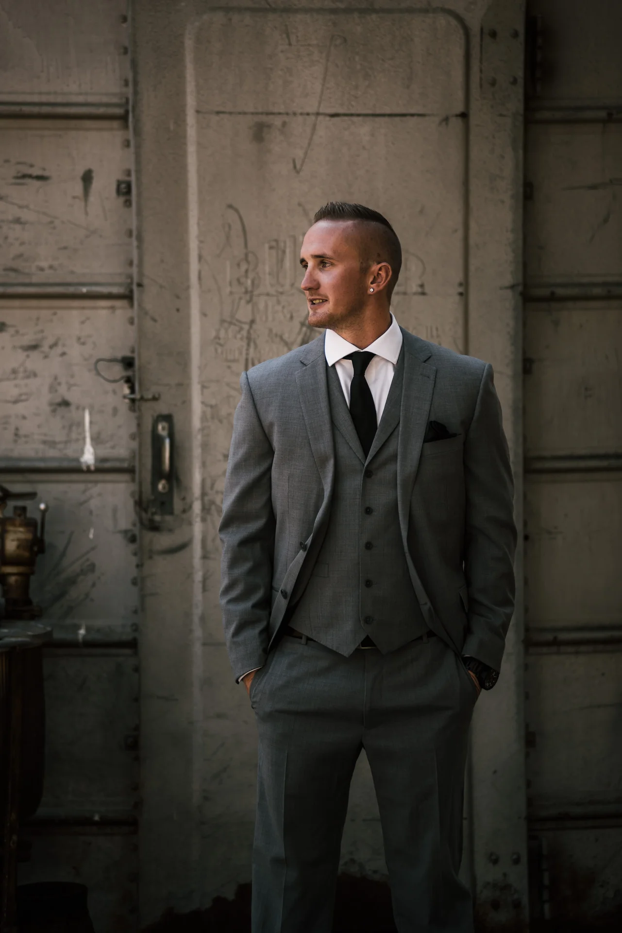 Groom in front of old silo waits for bride at the rustic Pymm ranch wedding venue in Temecula california