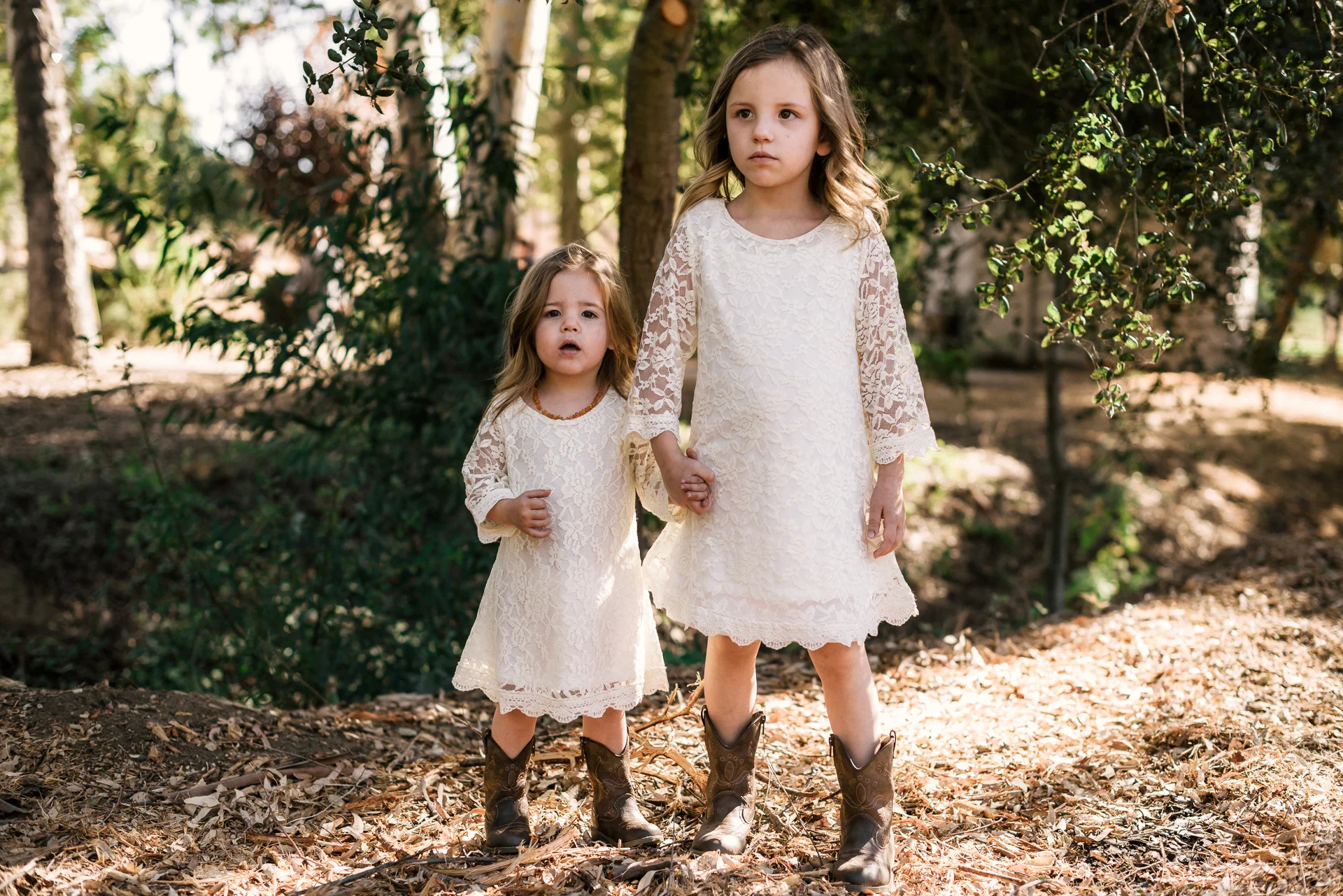 adorable flower girls wait for ceremony at rustic pymm ranch wedding venue in winchester california