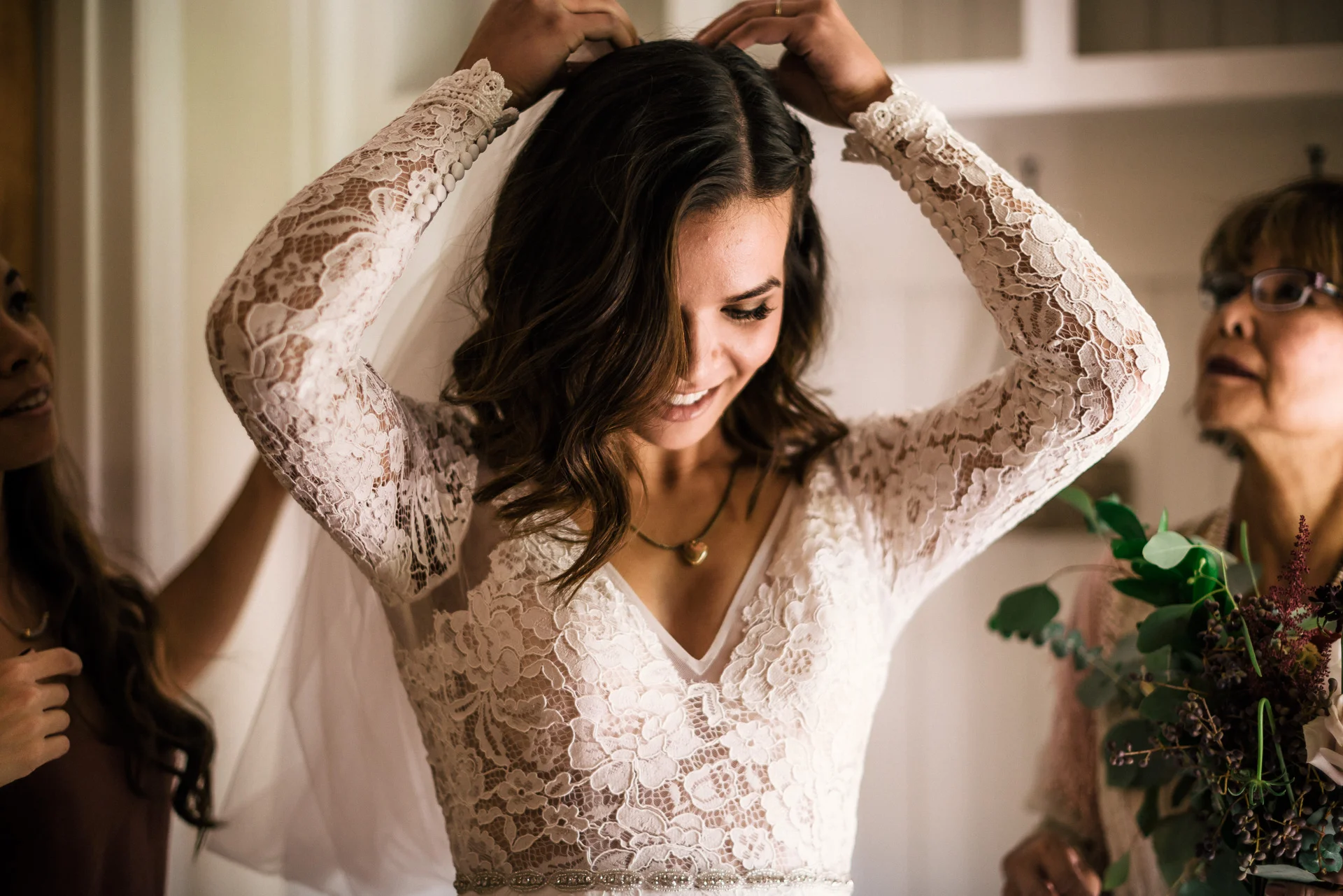 bride puts on her veil before ceremony at rustic pymm ranch wedding venue in winchester california