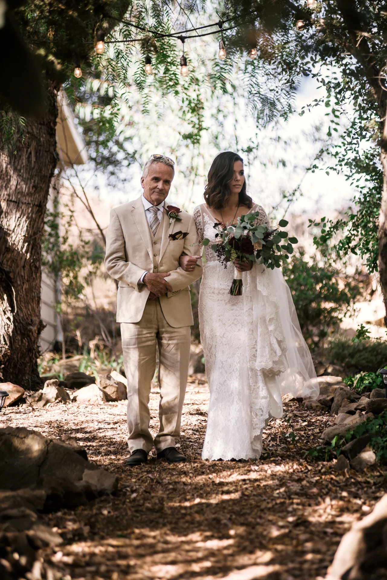 father prepares to talk his daughter down the aisle at rustic pymm ranch wedding venue in winchester california