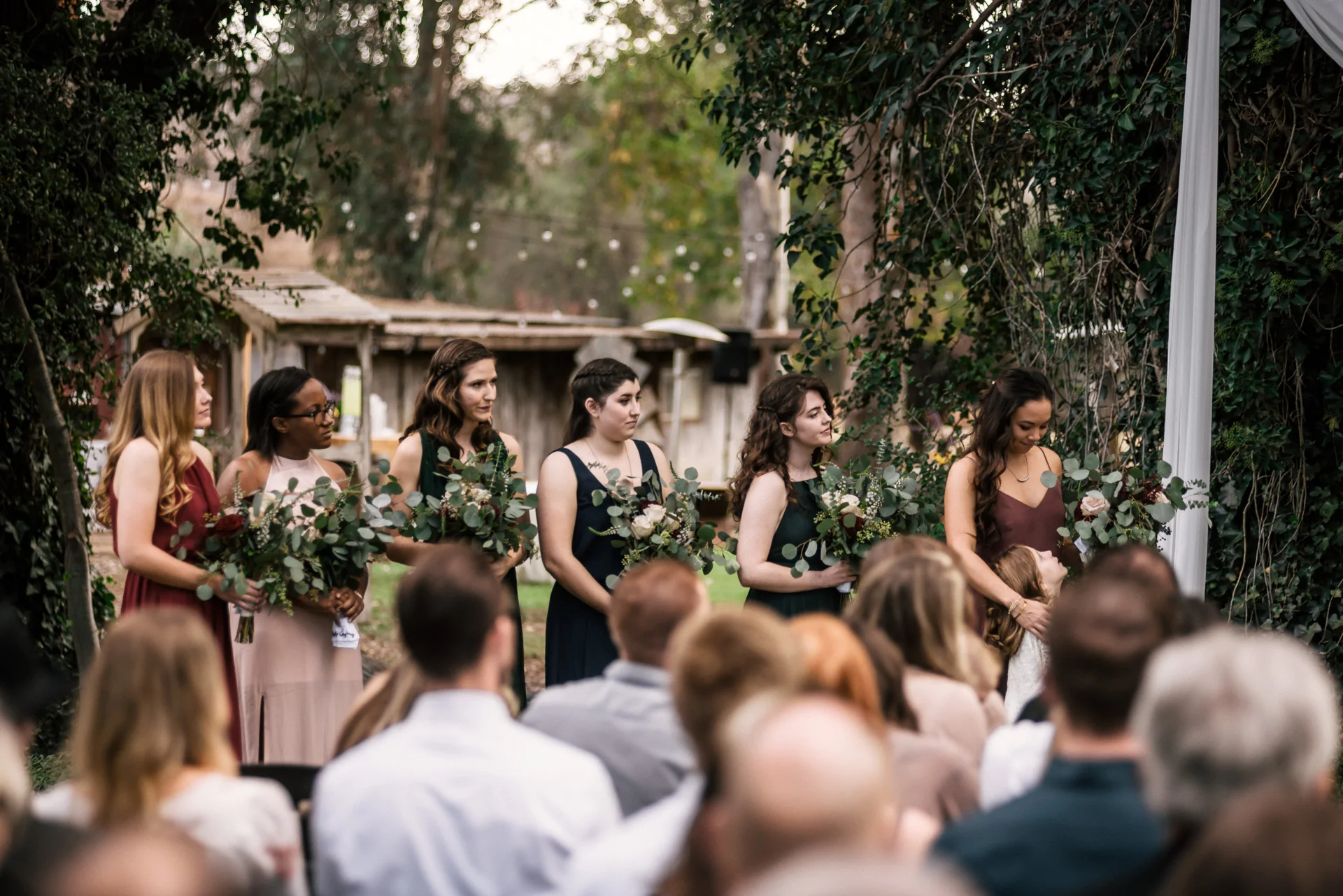 bridesmaids watch ceremony at rustic pymm ranch wedding venue in winchester california